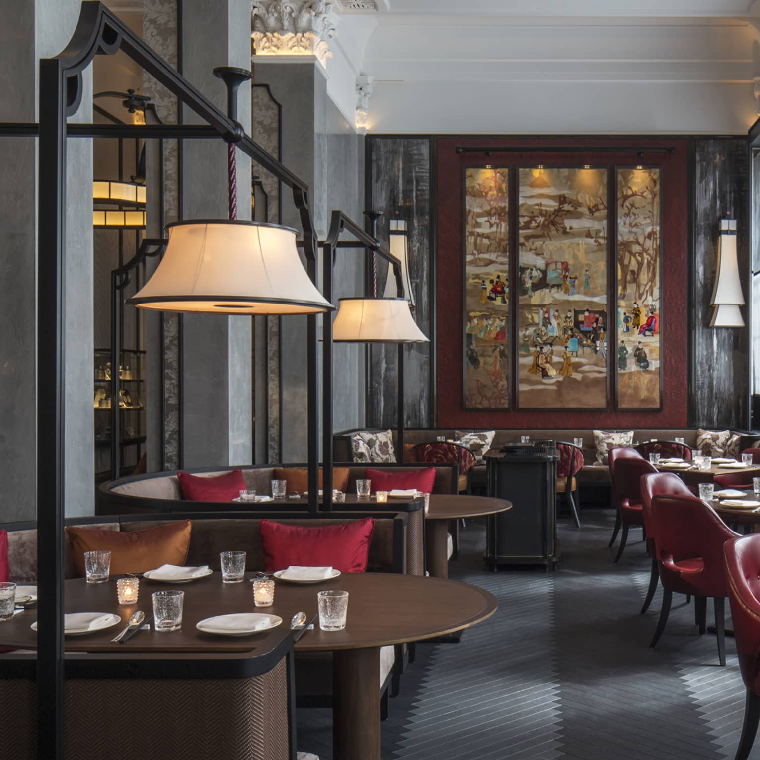 Wide view of Mei Ume dining room with brown tables, red chairs and red and brown accent pillows