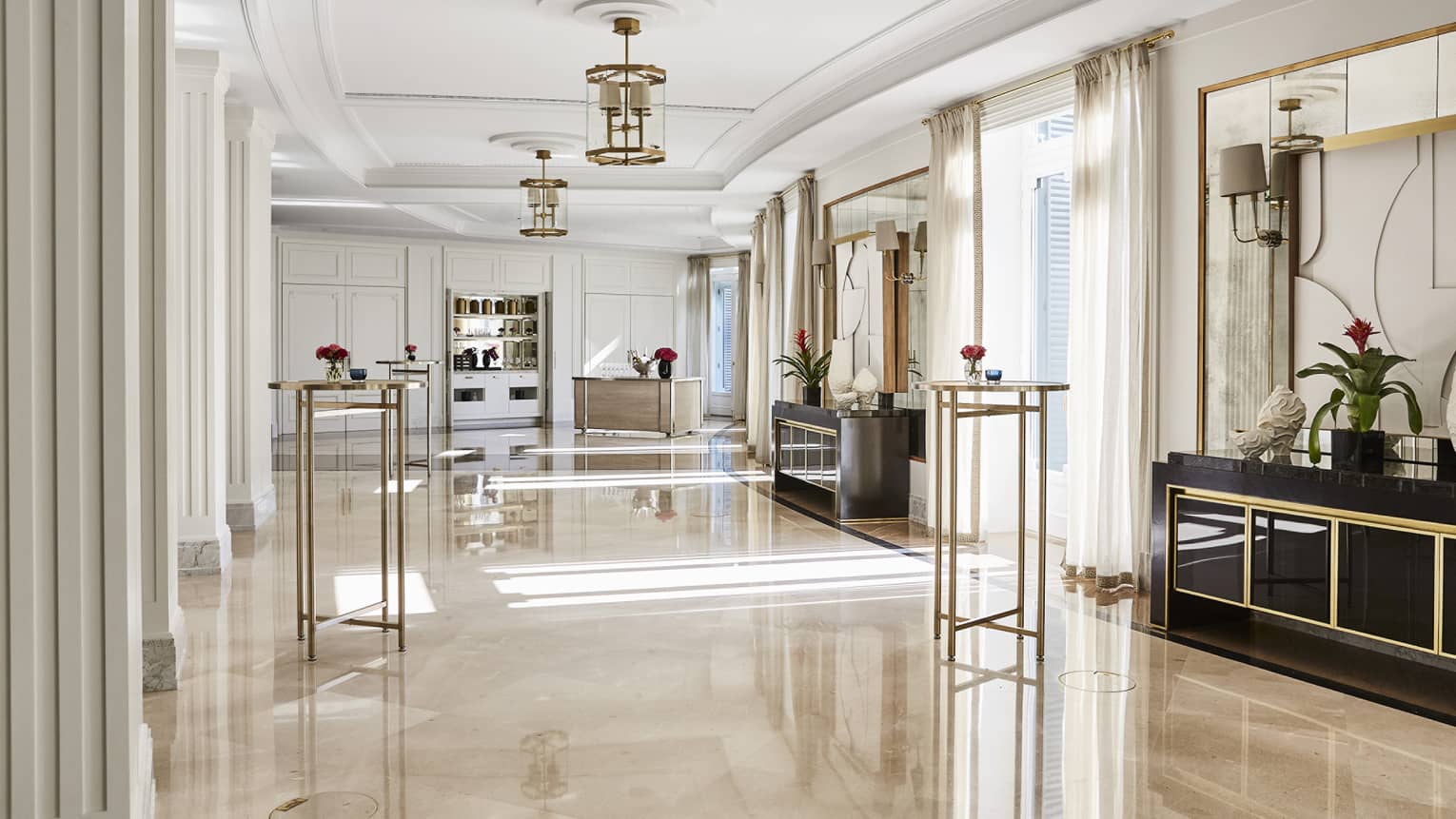 Spacious salon, marble floors, hanging chandeliers, windows