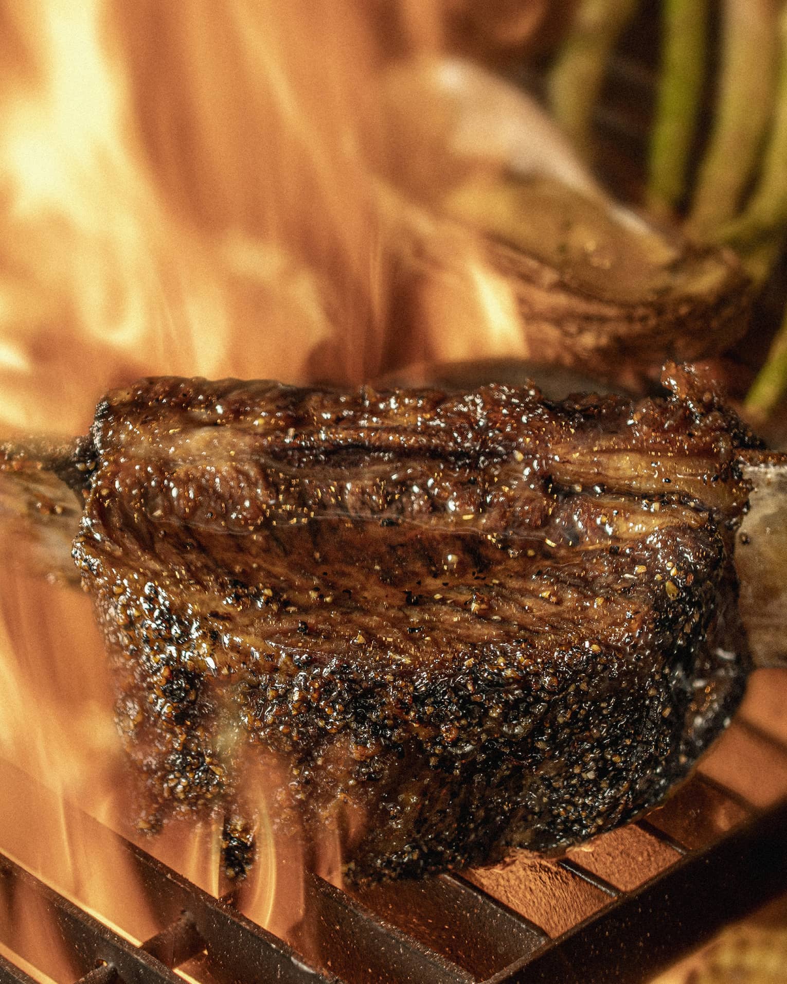 Close-up of chargrilled steak, asparagus and corn on grill grates