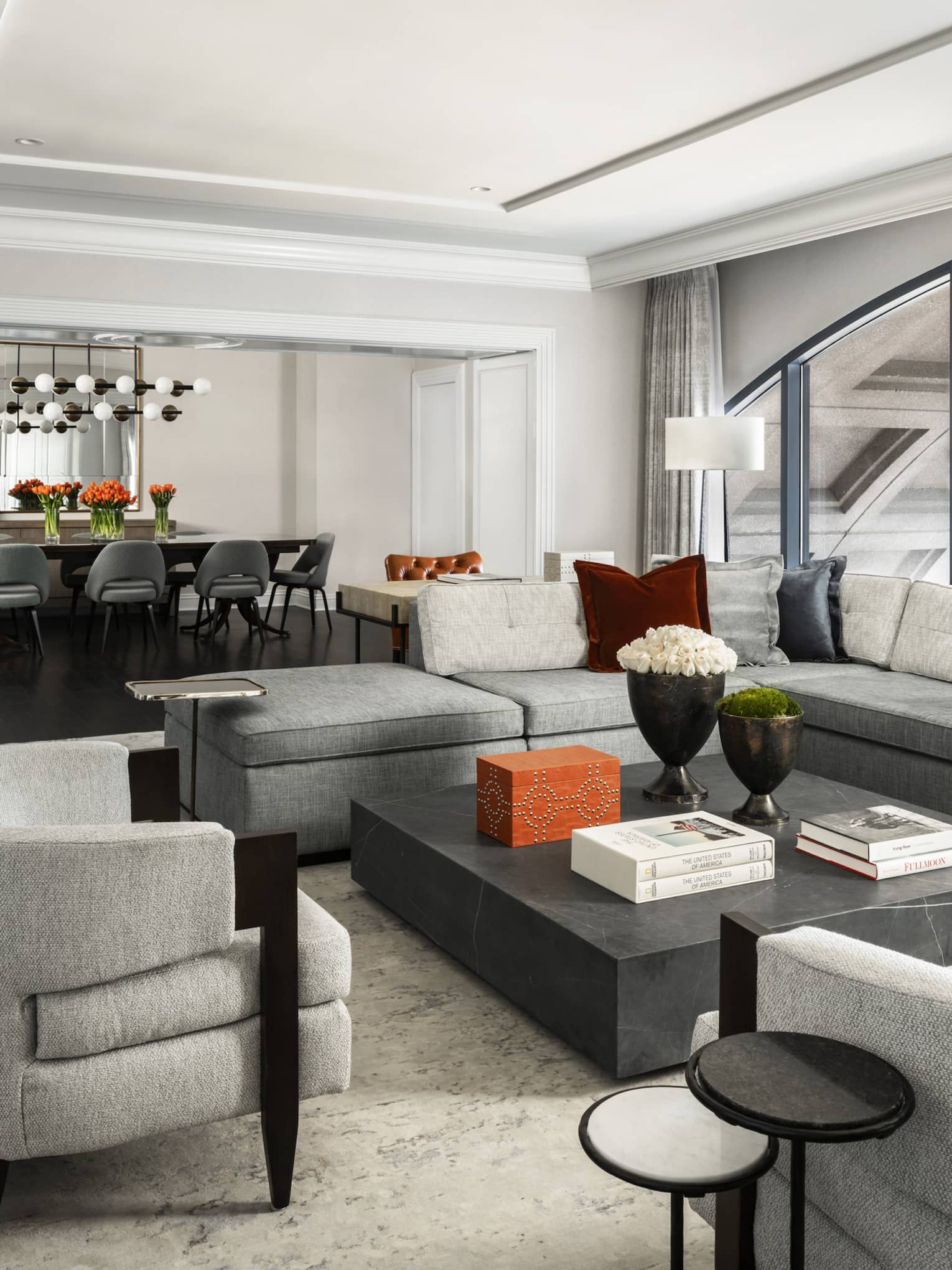 Presidential Suite large seating area with modern grey furniture, dining table