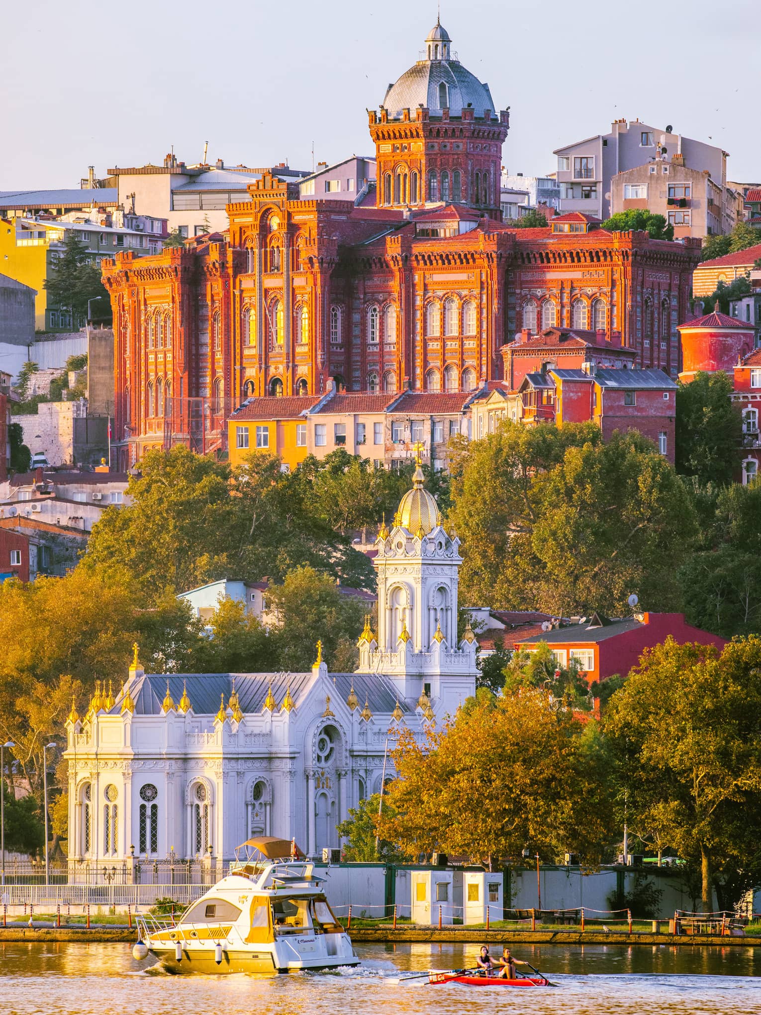 Bulgar Kilisesi-Fener Rum Lisesi buildings with turrets and boat on water