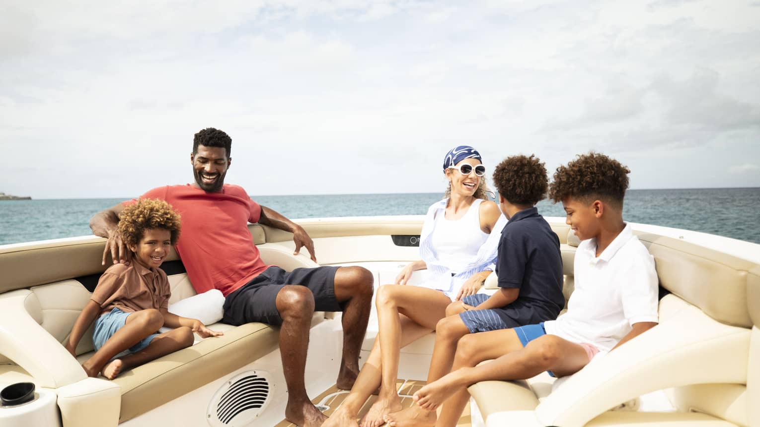 A family sits on a luxury boat on the ocean