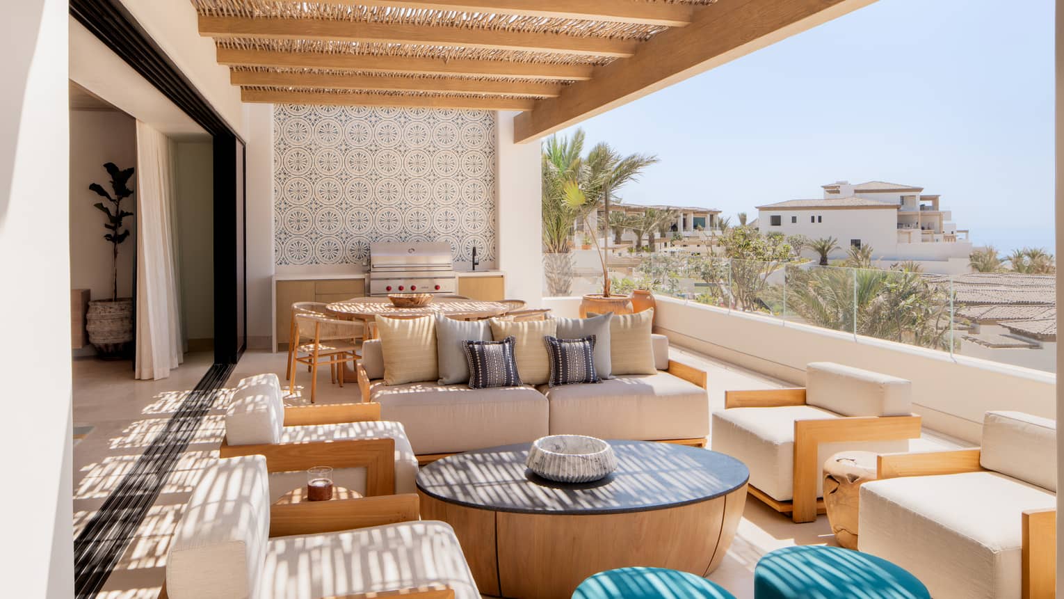 Covered ocean-view terrace of luxury villa, with lots of lounge seating, dining table and grill, at Four Seasons Resort Cabo San Lucas at Cabo Del Sol