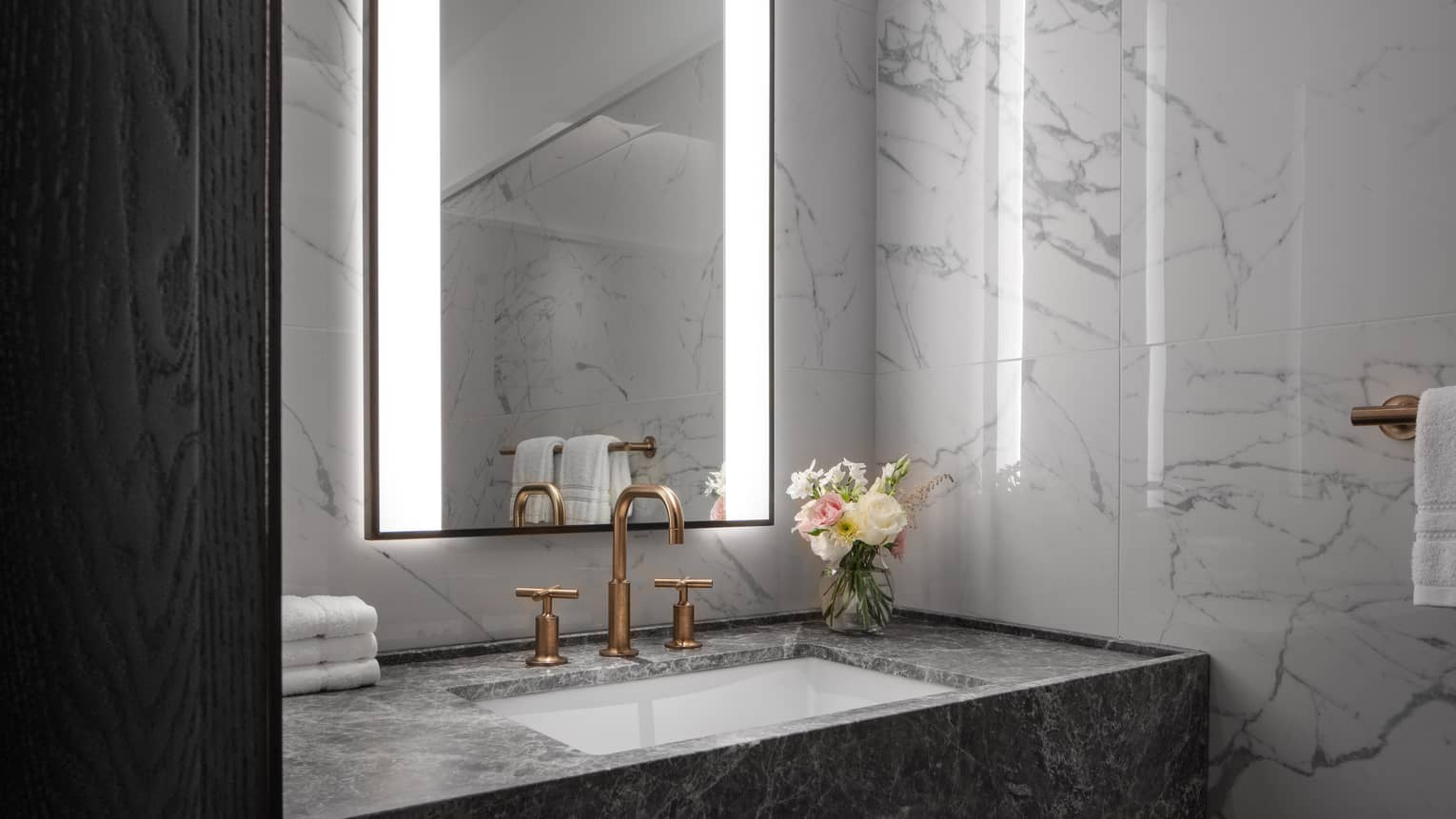 Marble bathroom vanity with illuminated mirror