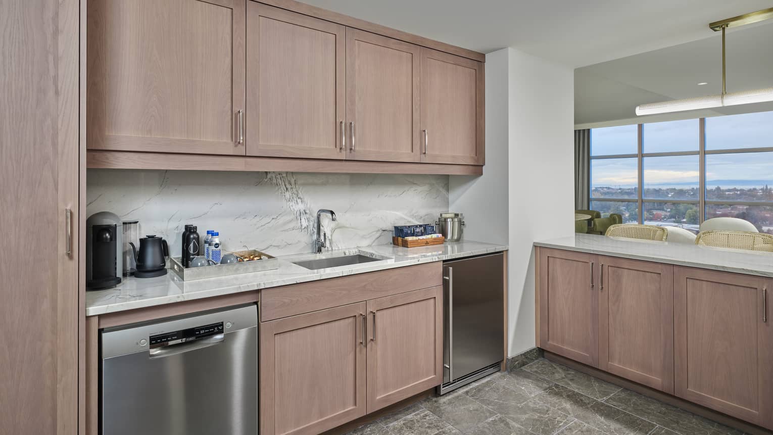 Kitchen with light wood cabinets, grey tile floor