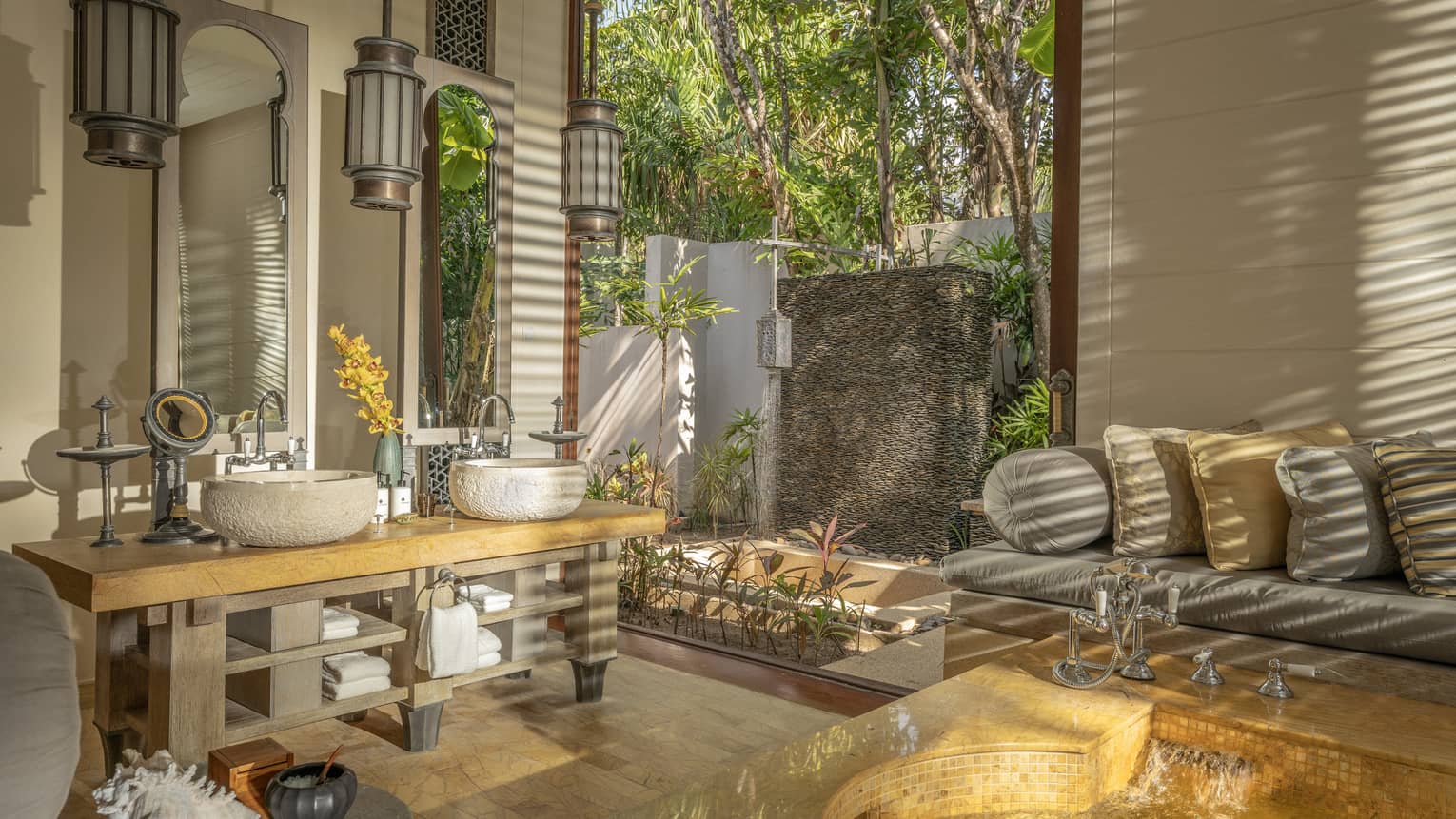 Large bathroom with natural materials, sofa and outdoor shower