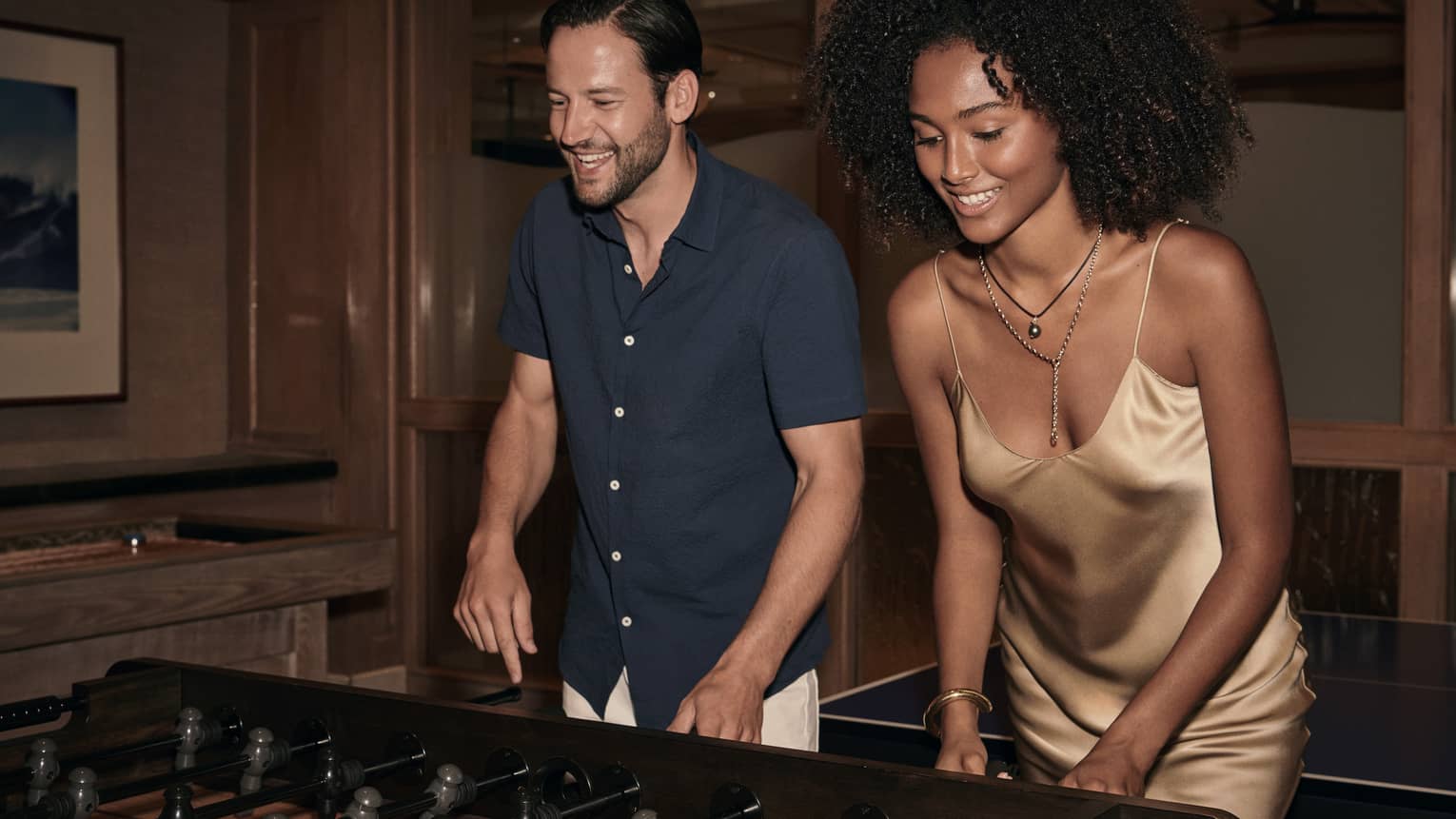 Man and woman play foosball