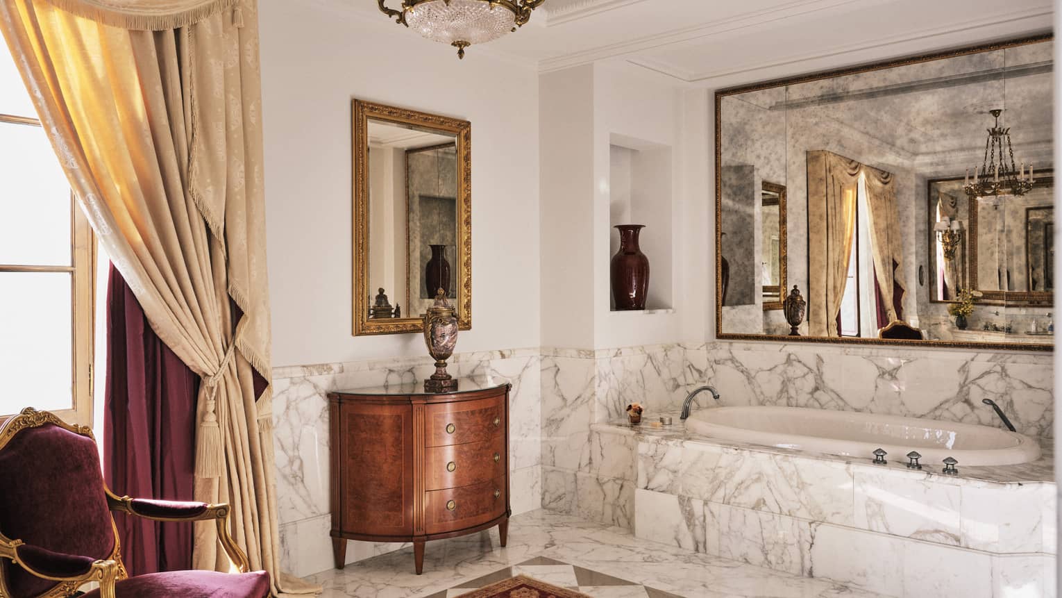 Presidential Suite marble bathroom with chandelier, velvet chair, window and tub, at Four Seasons Hotel Florence