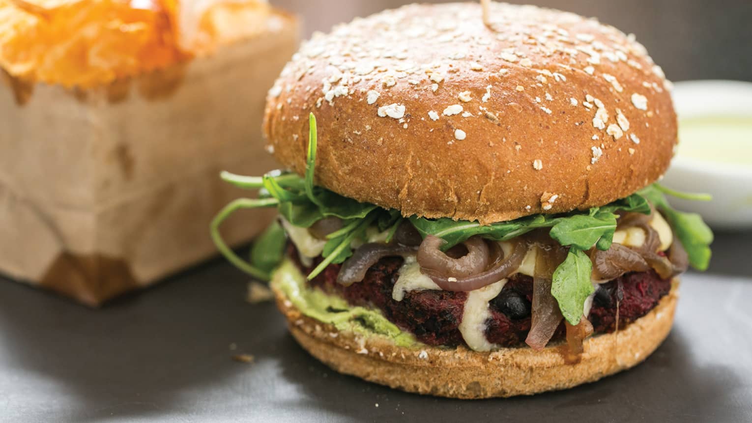 Close-up of Vegan Burger black bean and mushroom patty, onions, lettuce and bun