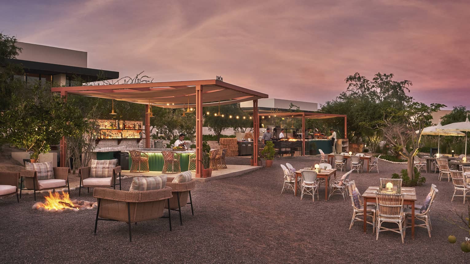 An outdoor eating area with a pink and blue sky above.