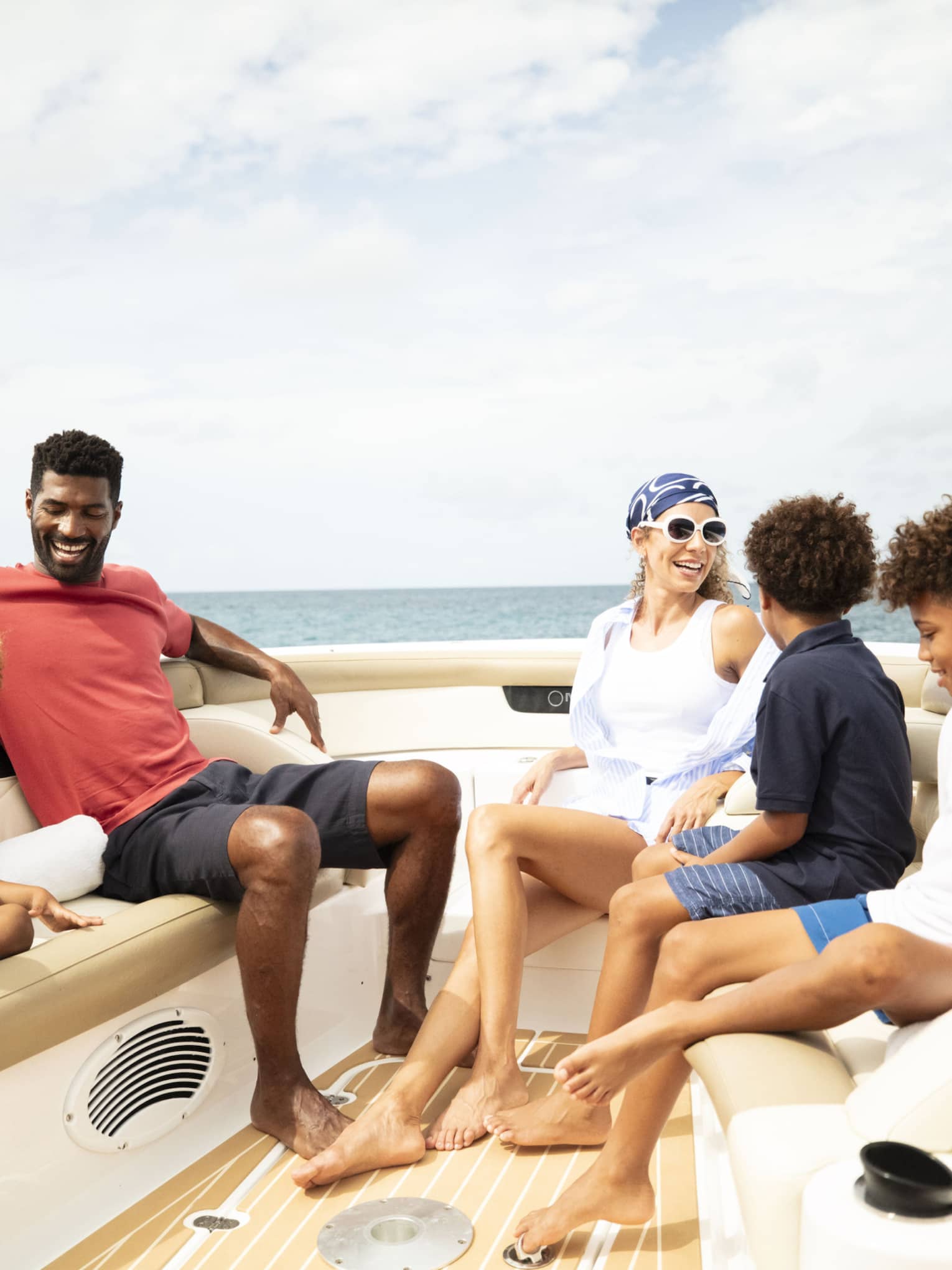 A family sits on a luxury boat on the ocean