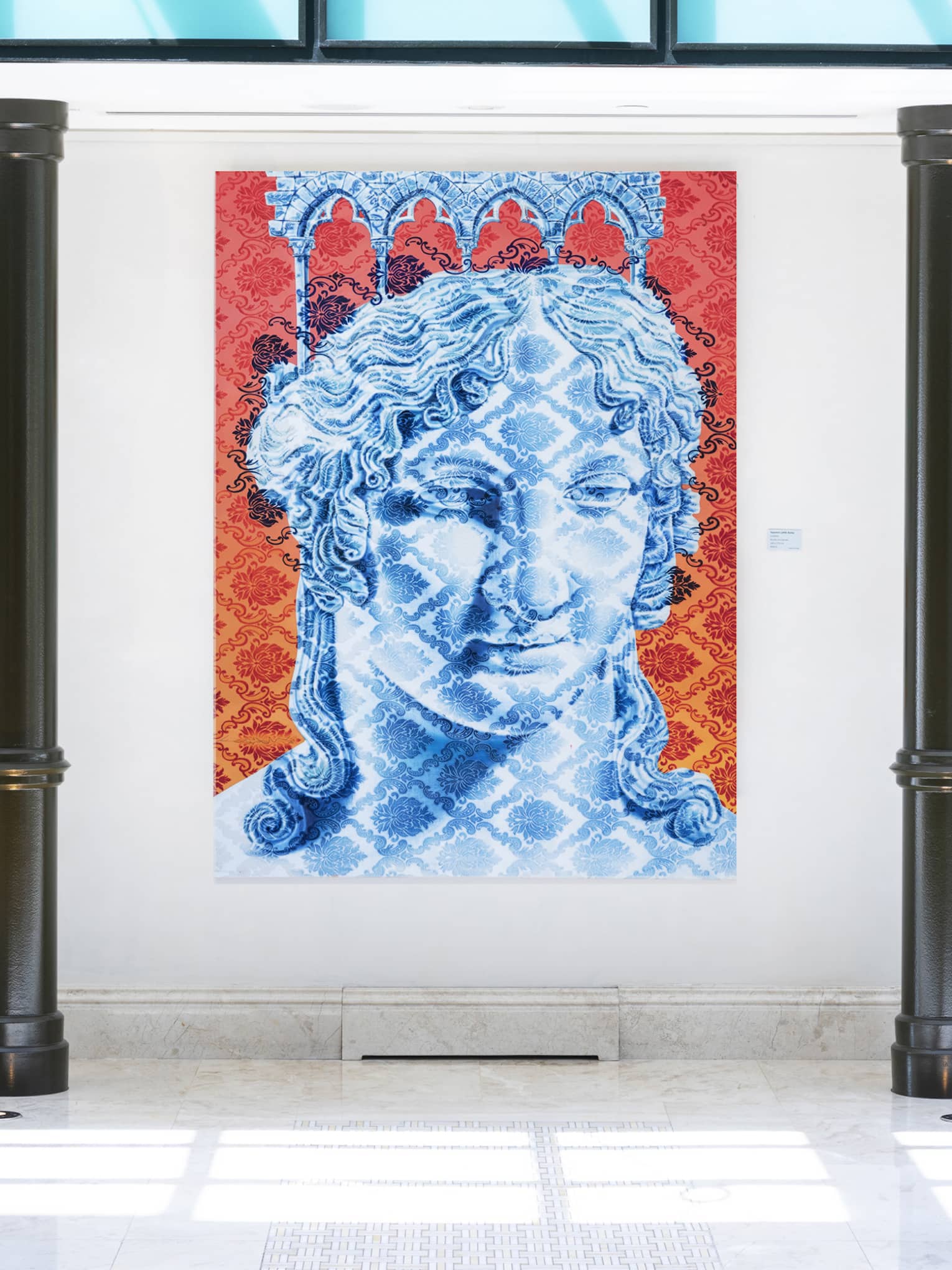 Modern lobby with black pillars and blue, red and white portrait painting