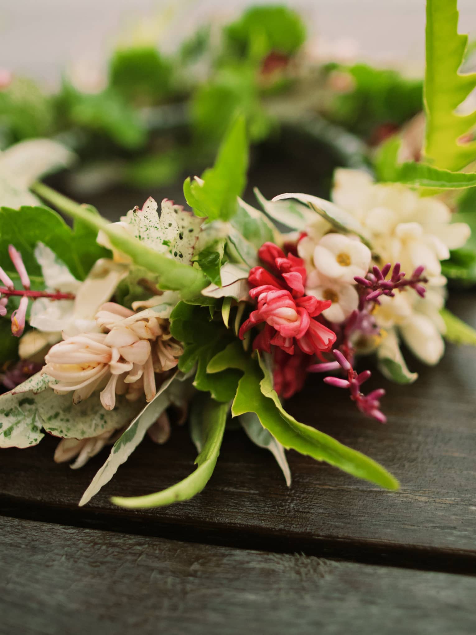 Tropical flowers arranged in floral wedding crown on table