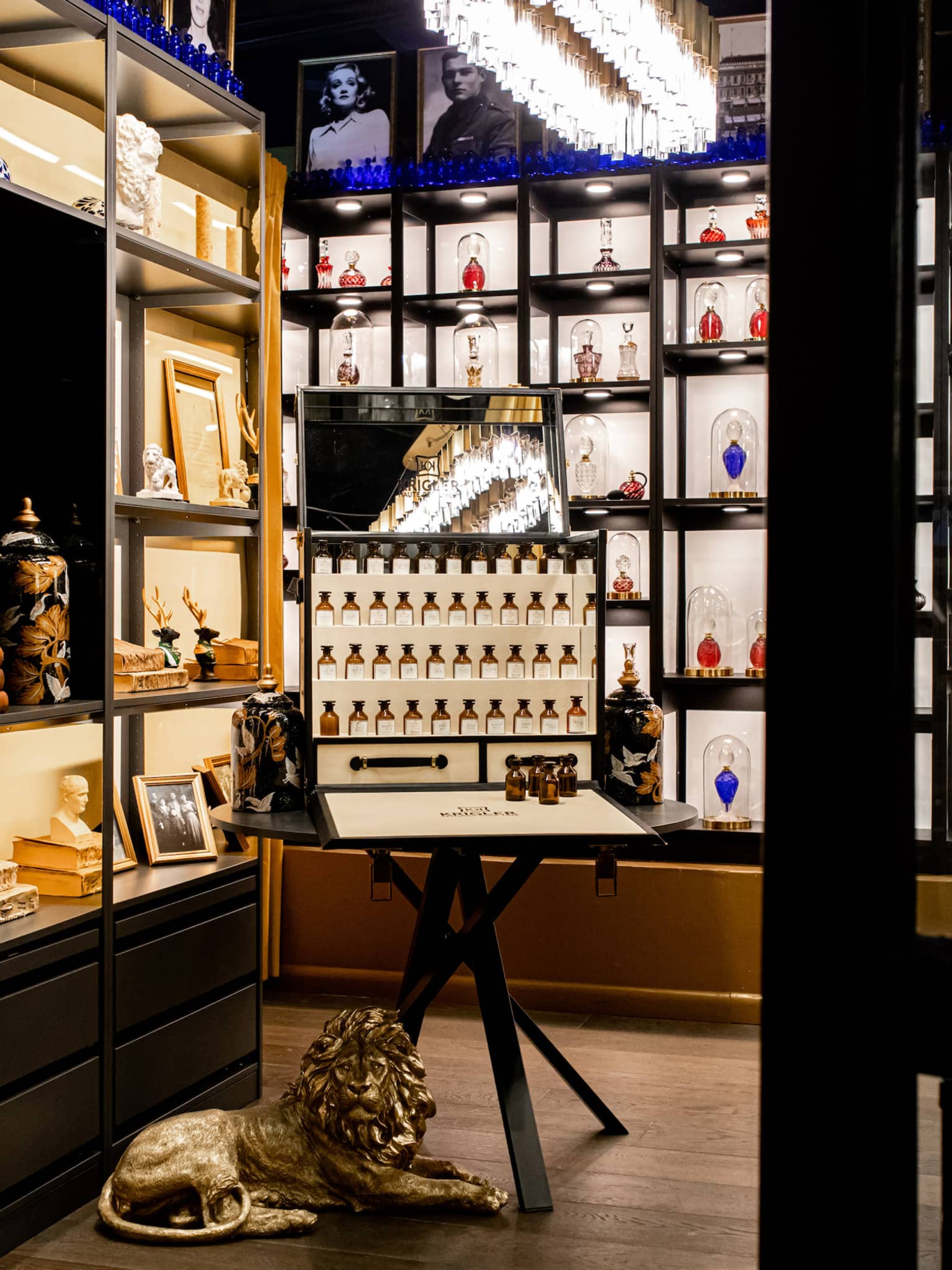 Store with various perfumes on display and a small marble sculpture.