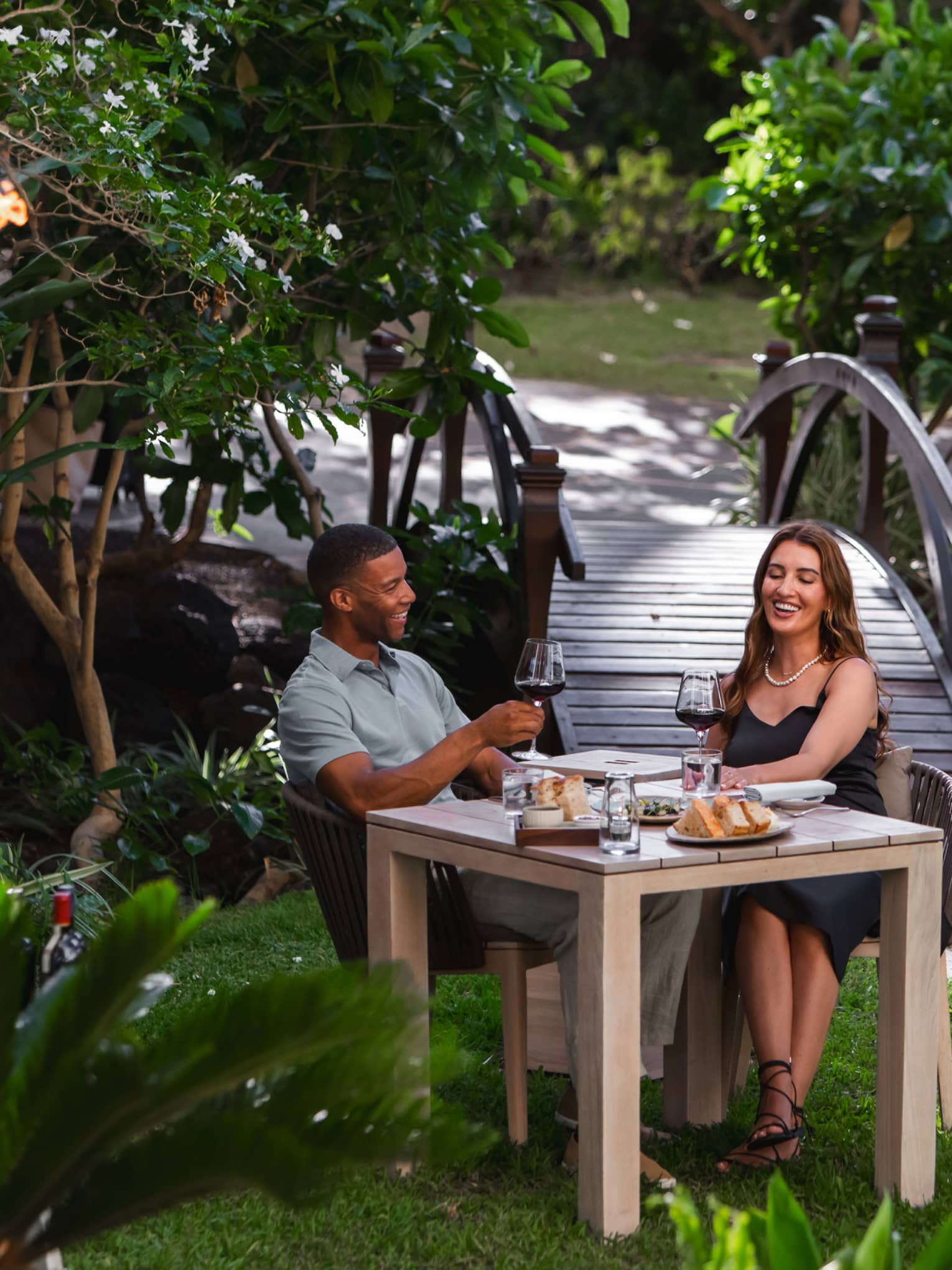 Man and woman dine at private table in Hawaiian garden