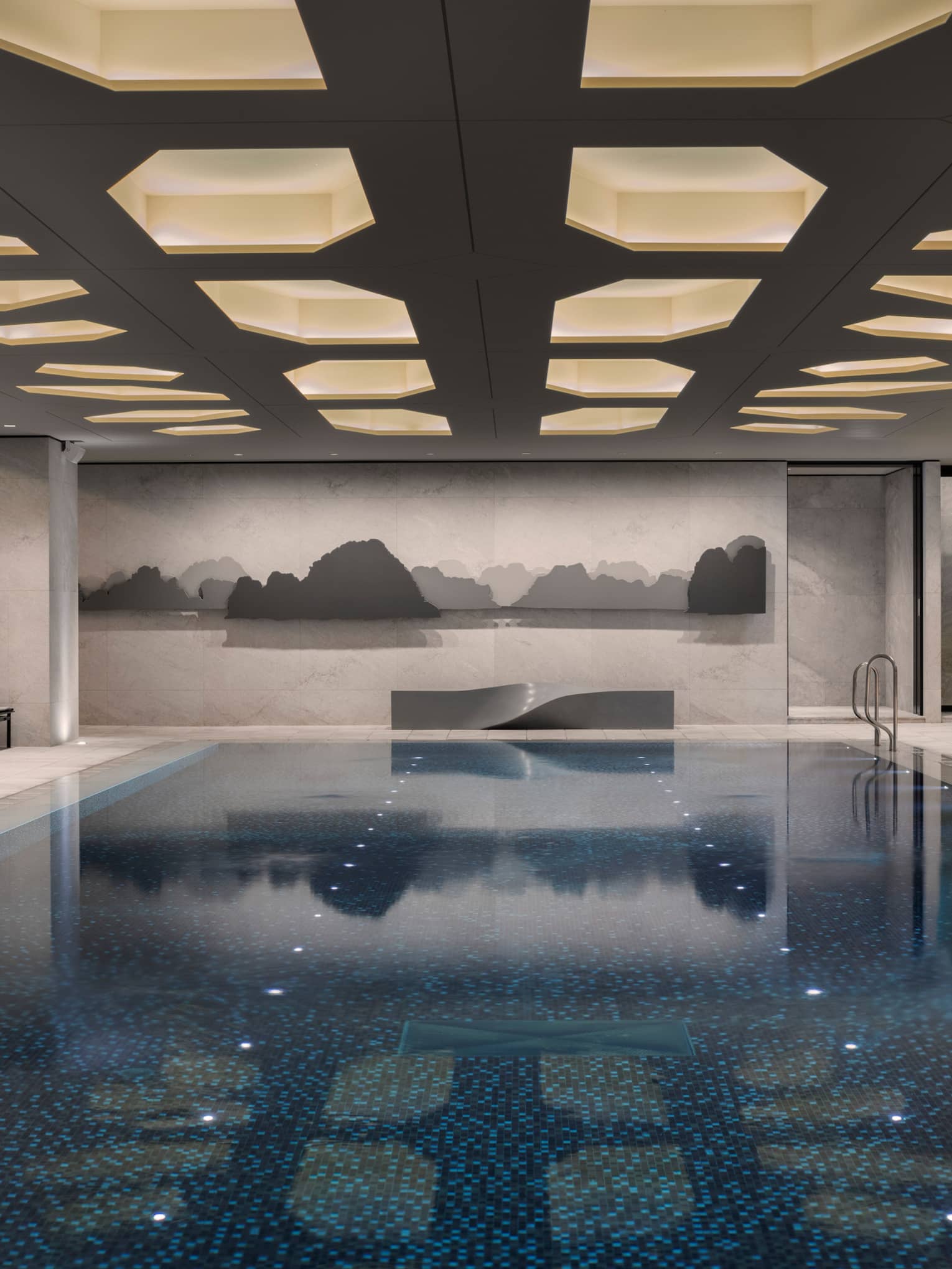 Indoor swimming pool under ceiling with recessed lights