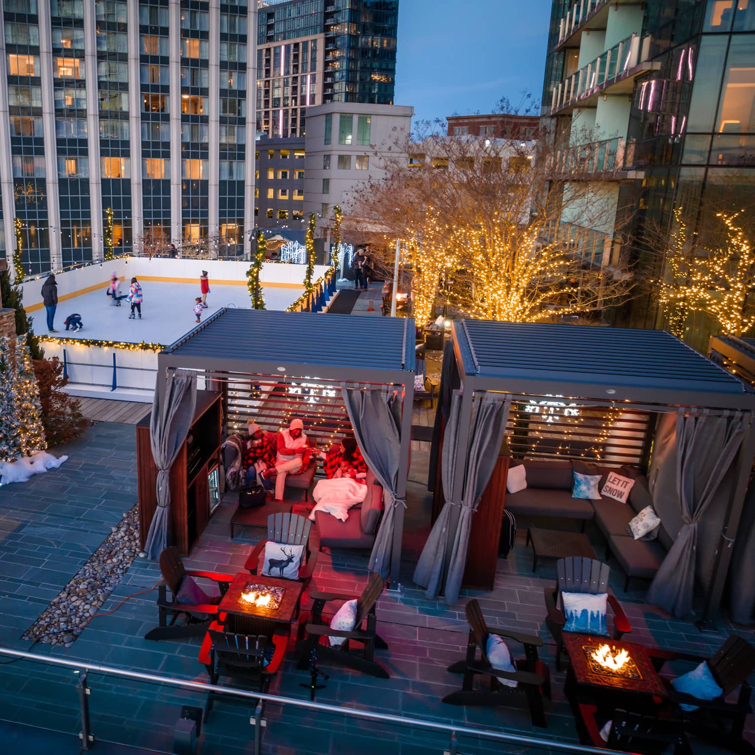 A rooftop with ice skating, and chalets.