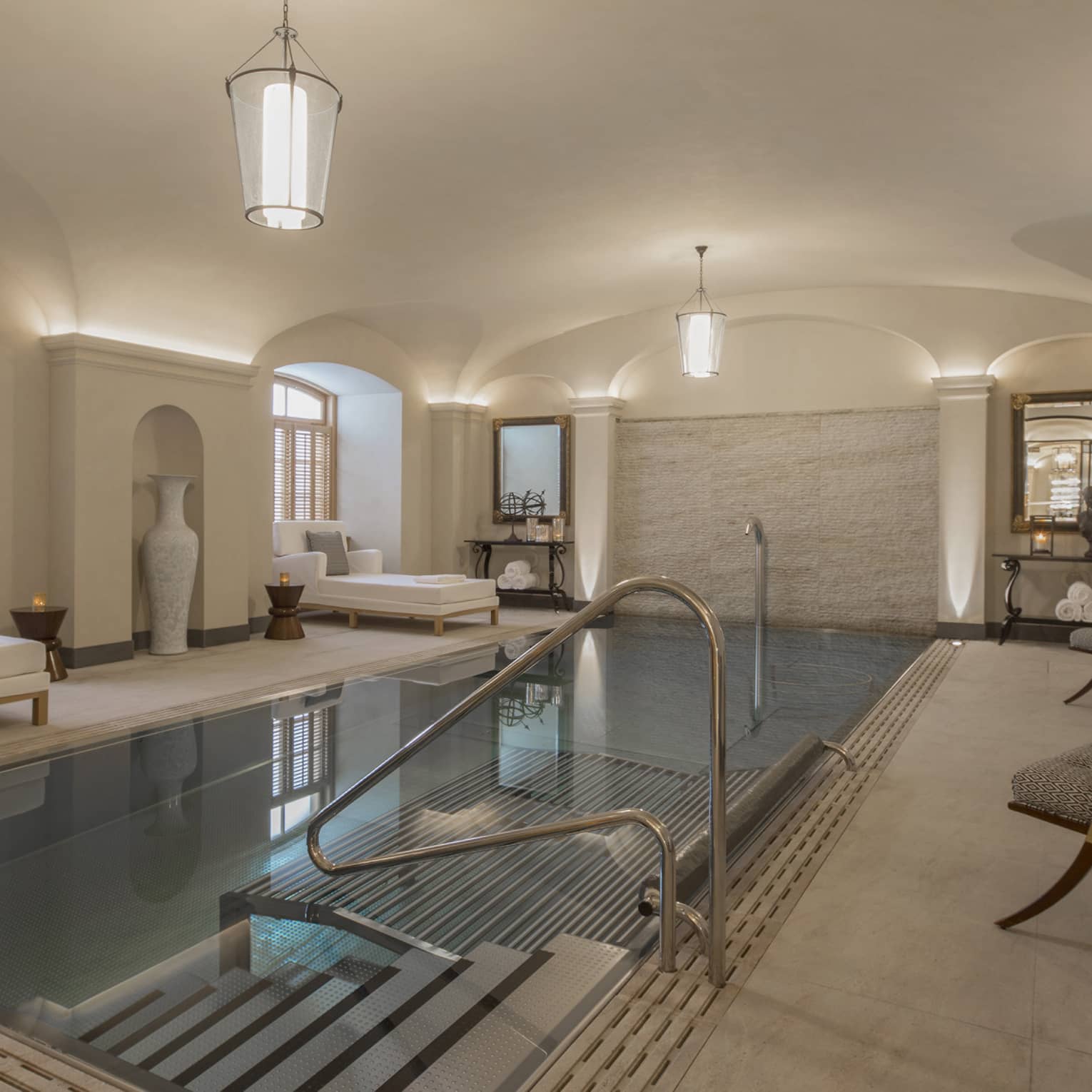 AVA Spa vitality pool  flanked by white lounge chairs under domed ceiling