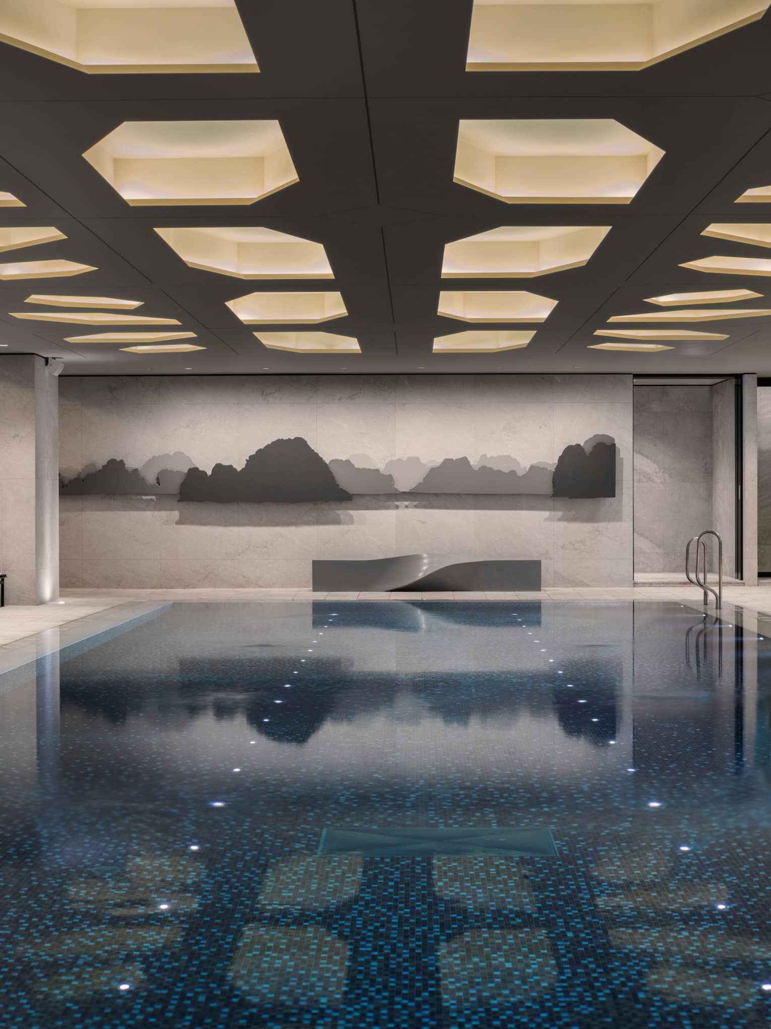 Indoor swimming pool under ceiling with recessed lights
