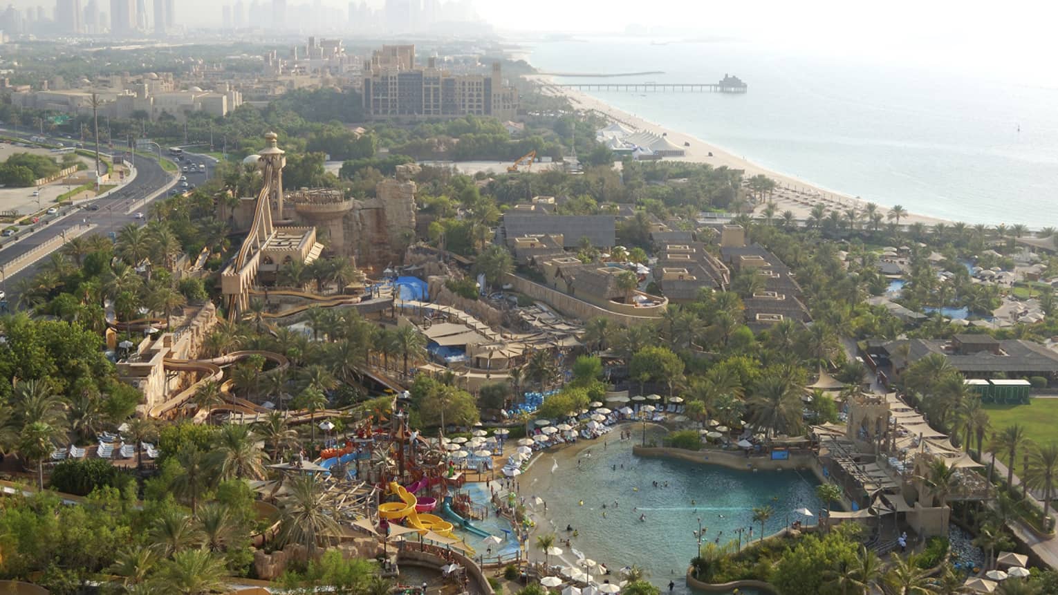 Aerial view of Wild Wadi Waterpark with waterslides, Dubai skyline visible