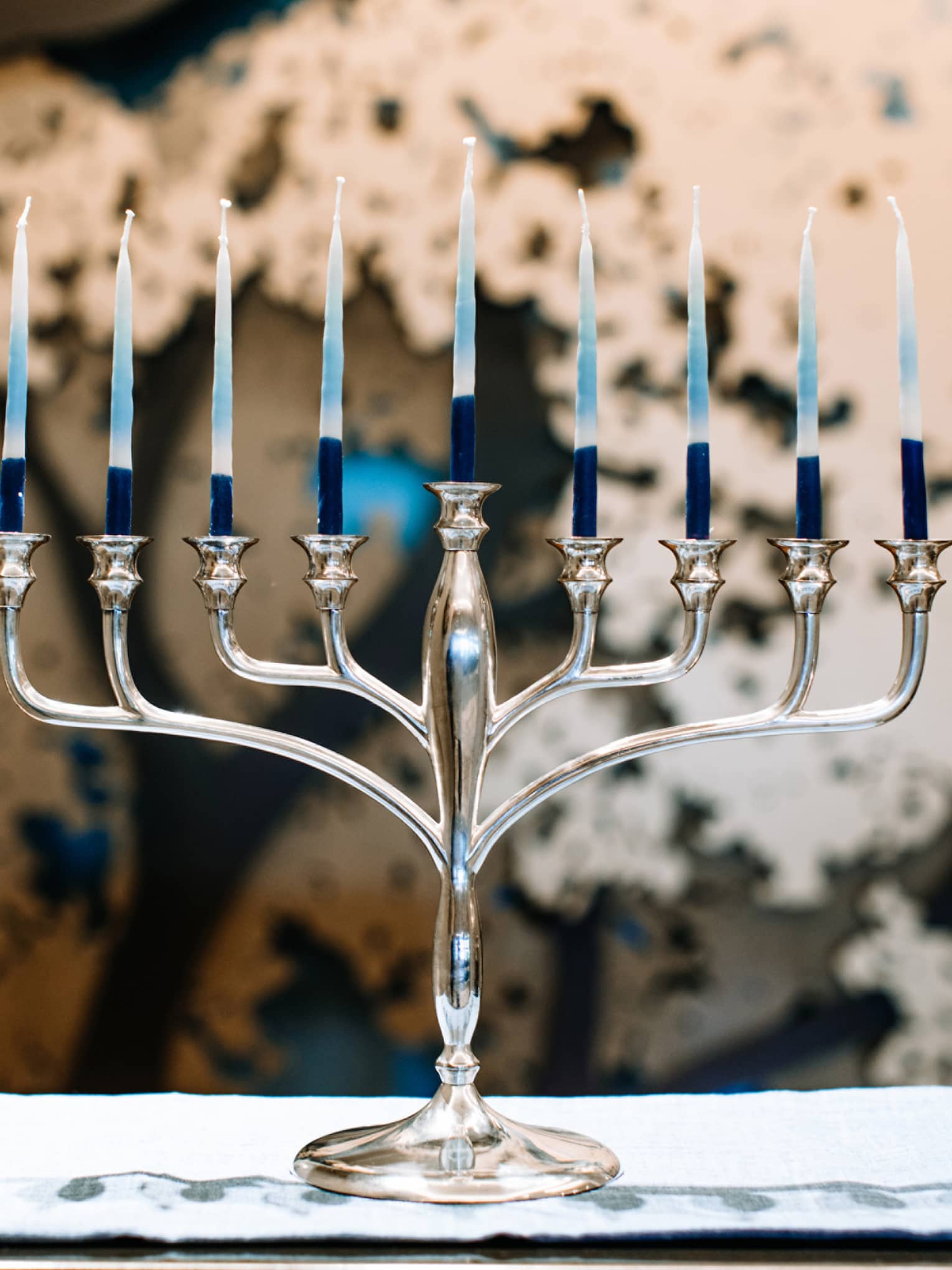 A silver menorah with 9 candles.
