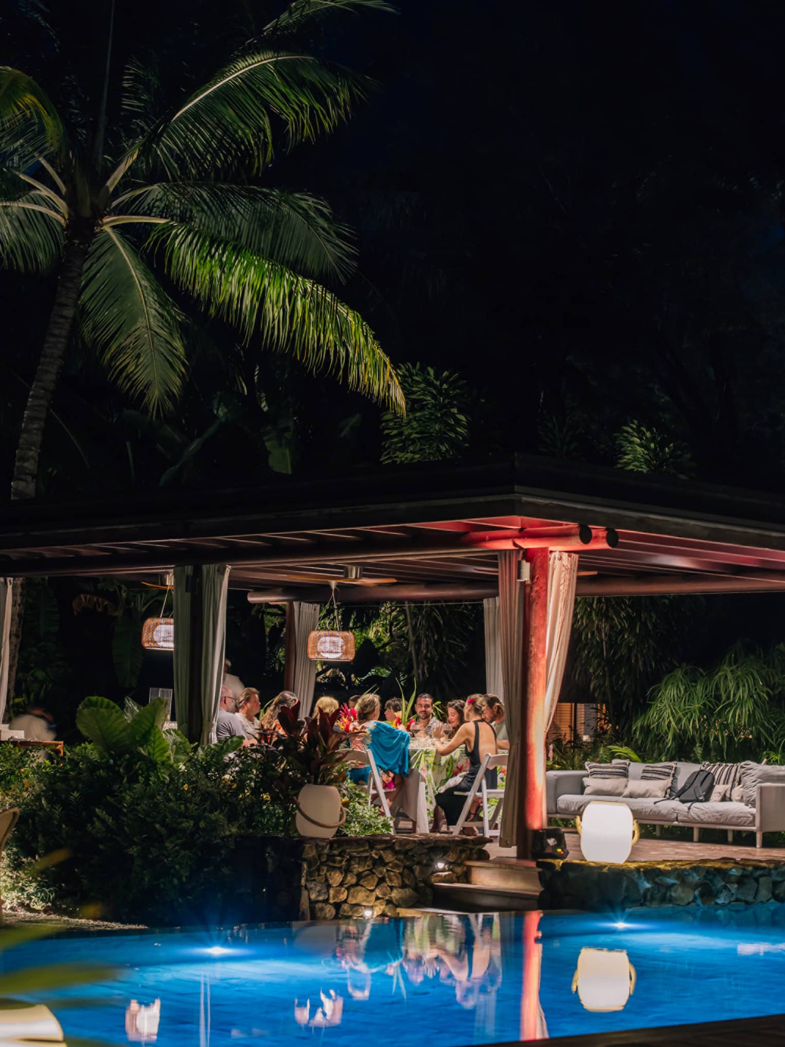 Dinner party at night by the pool at Four Seasons Resort Bora Bora