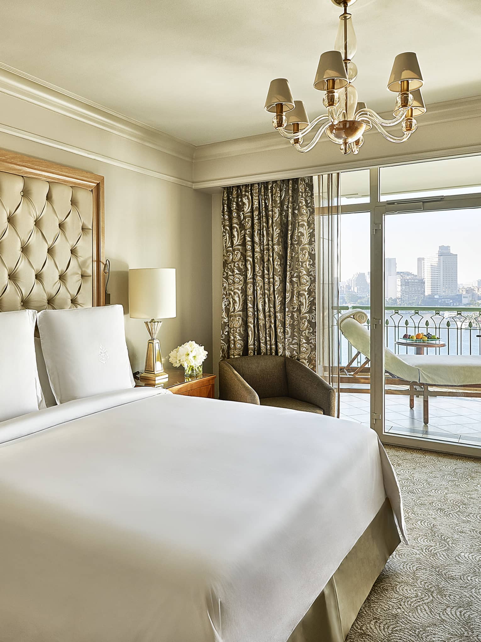 Four Seasons Suite, showing white-dressed bed and city views from windows