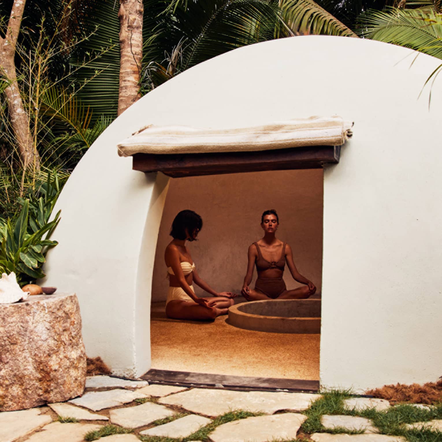 A heated dome shaped room surrounded by trees.