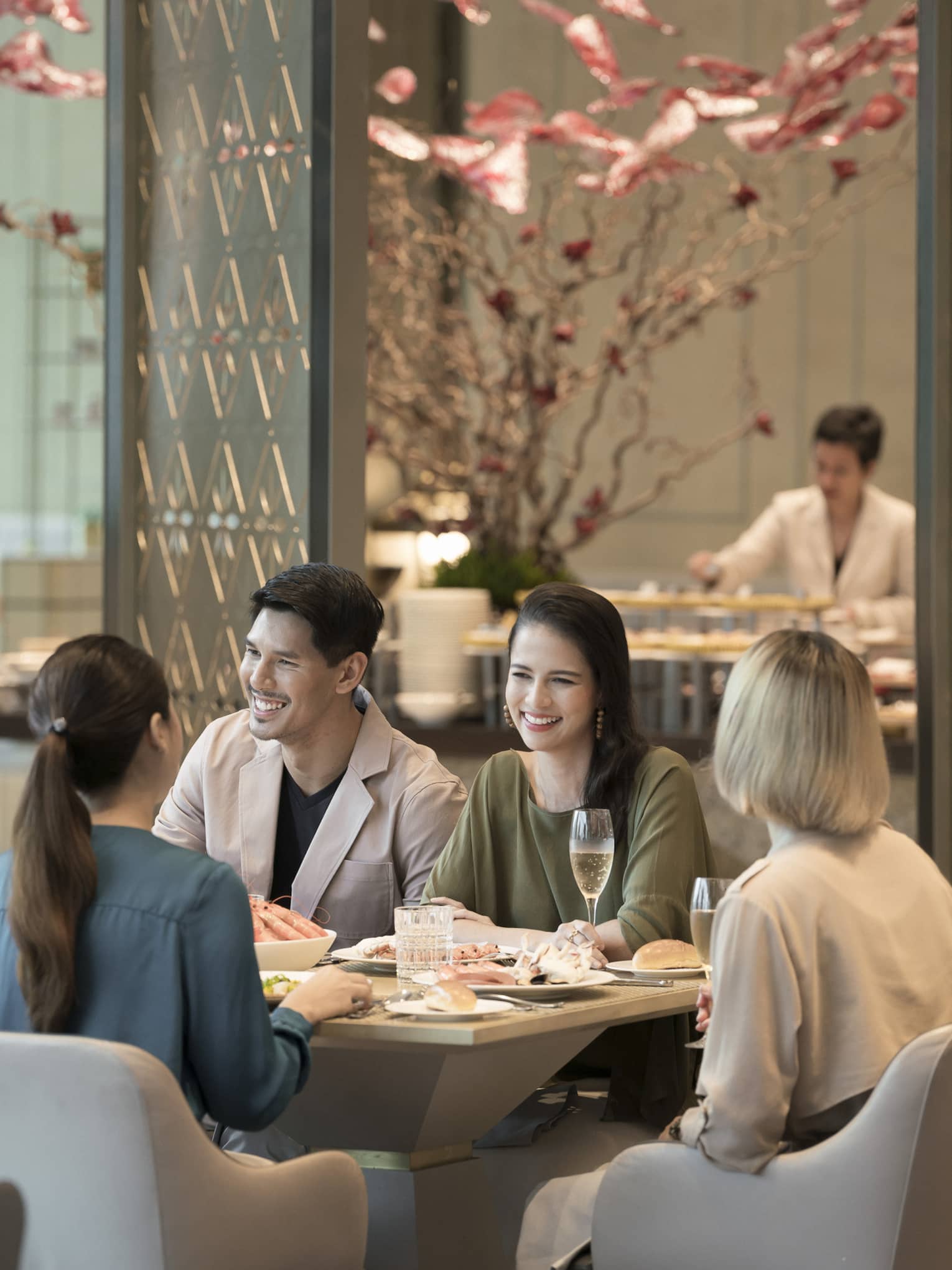 Group of laughing friends enjoy brunch at Curate