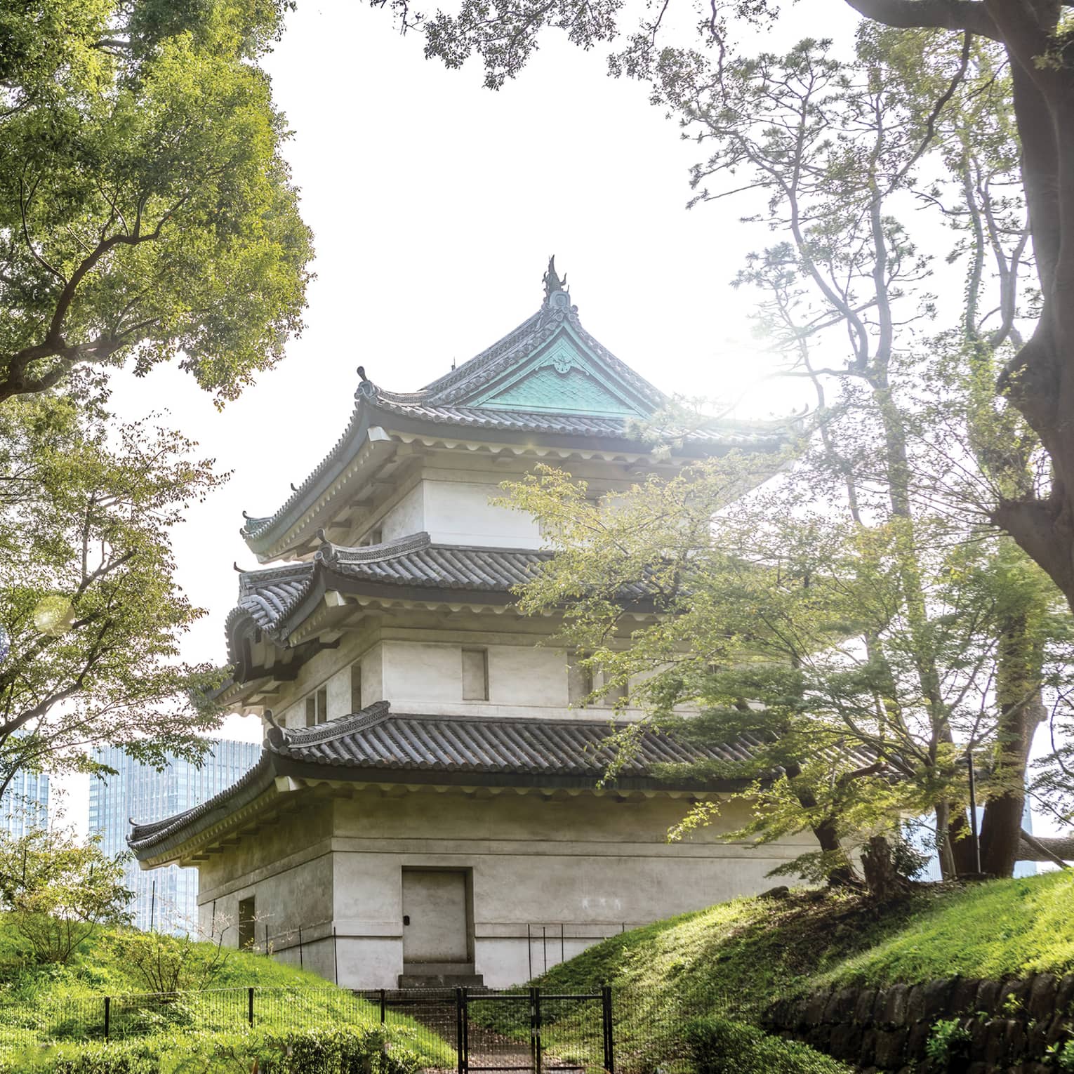 Traditional Japanese building with tiered roofs surrounded by trees