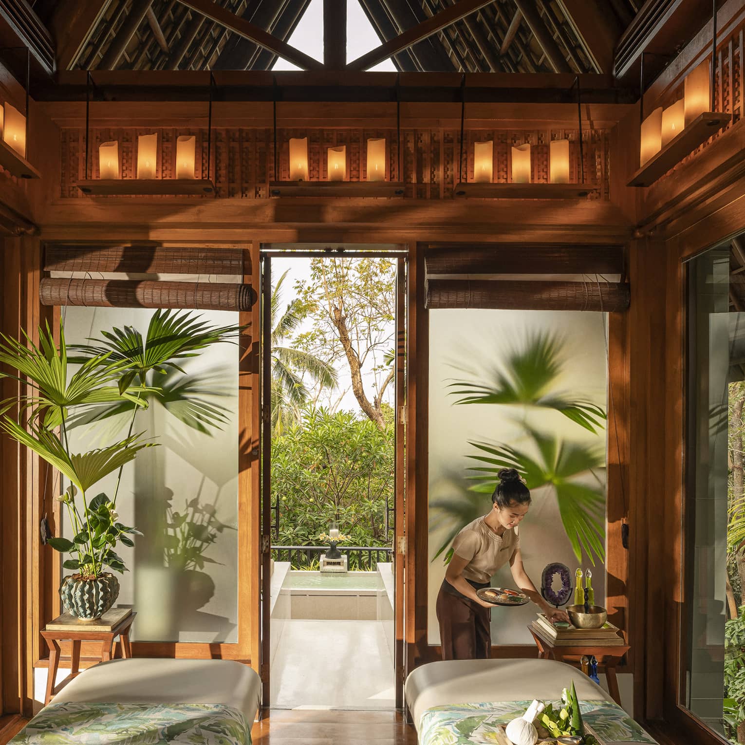 Spa team member prepares couples treatment room