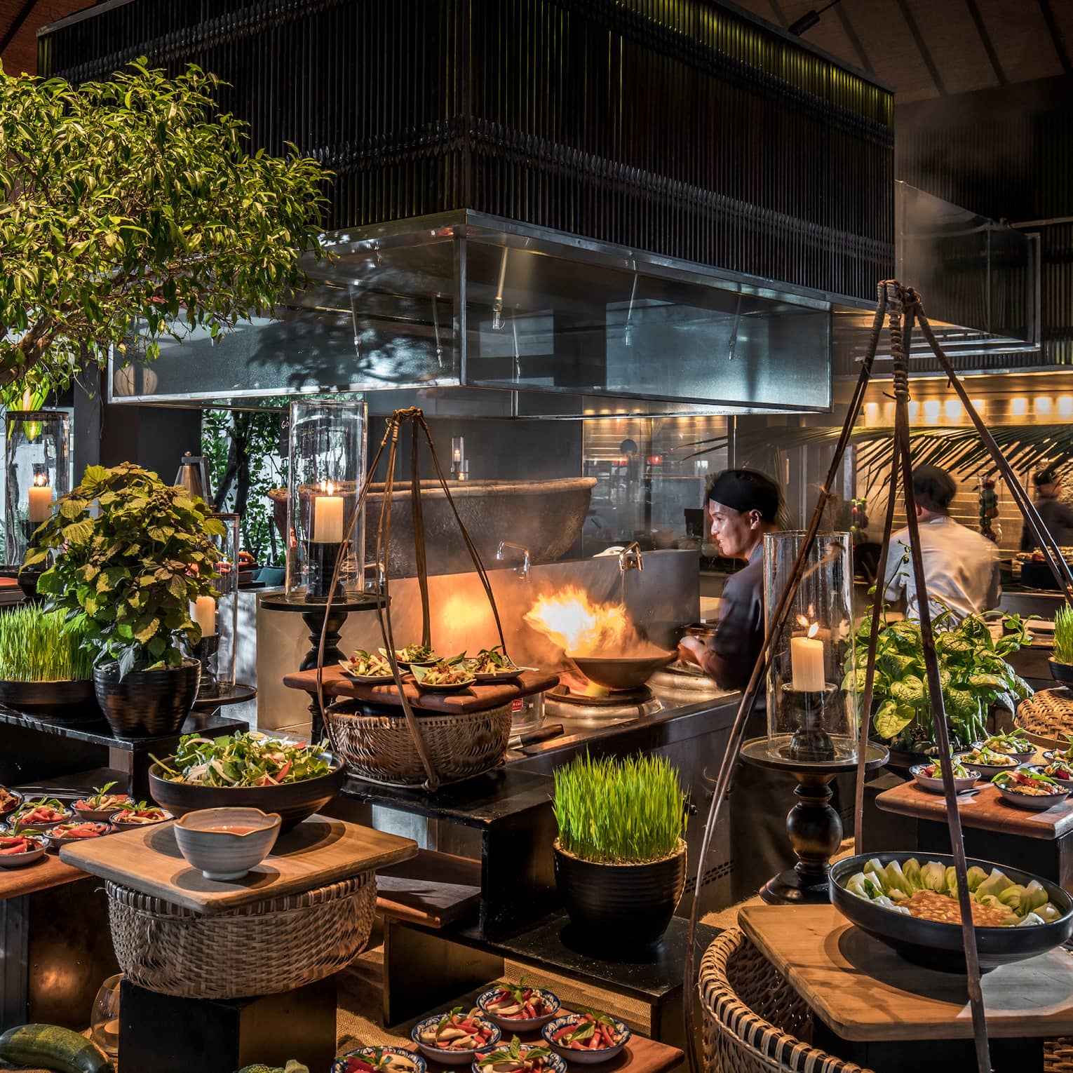 Chefs toss woks, flames around stoves, baskets of produce at The Nam Hai Cooking Academy