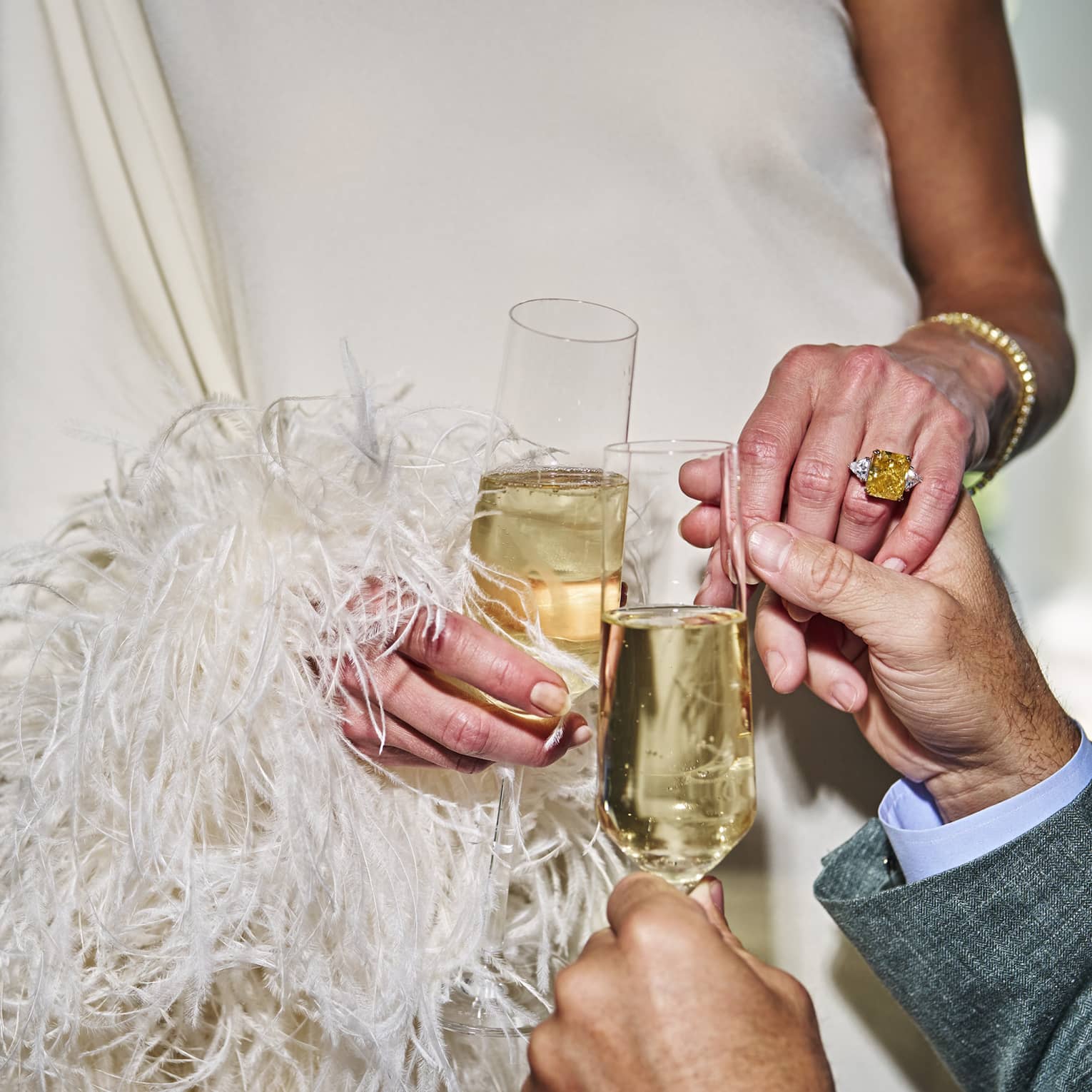 Two people holding glasses of champagne.