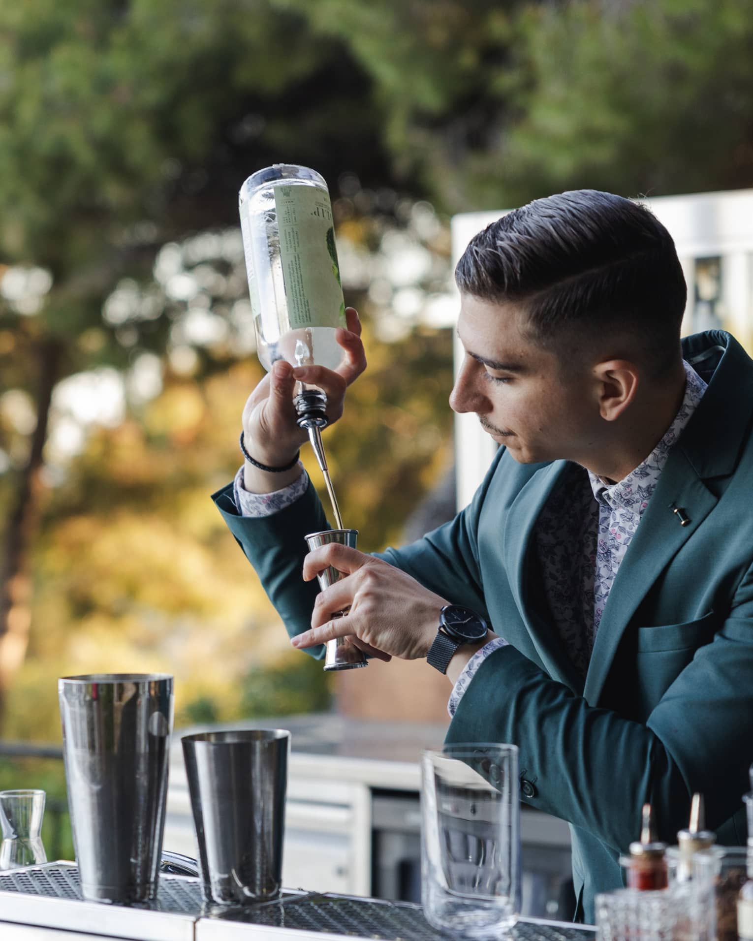 A bartender making a cocktail at an outdoor bar
