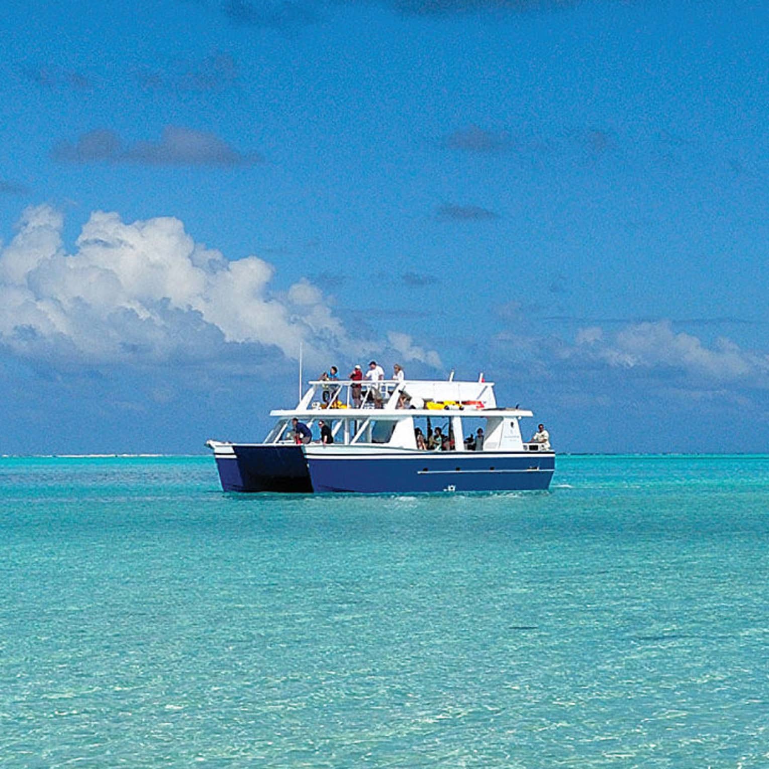 Guests on Four Seasons catamaran boat on lagoon