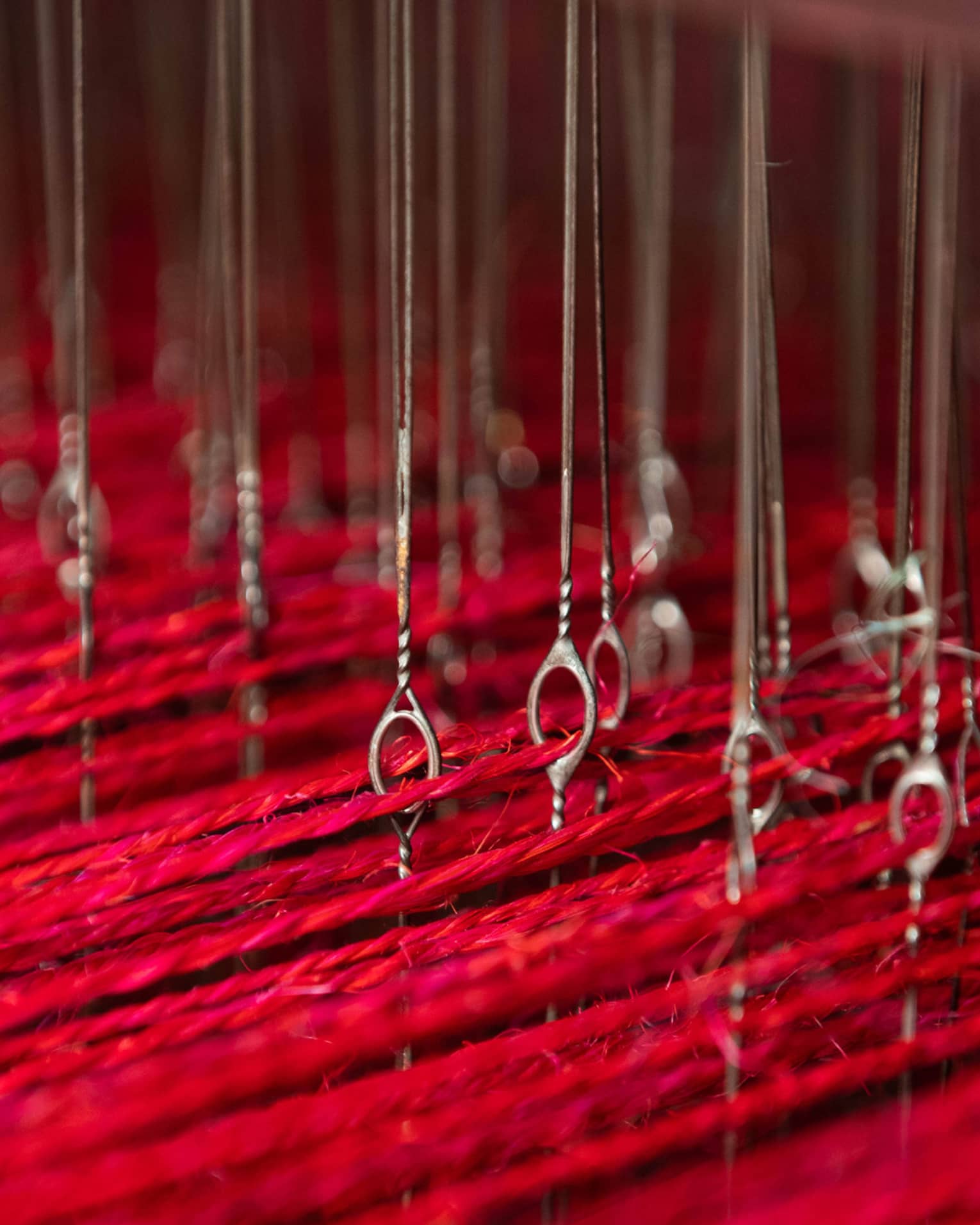 Long pieces of red string suspended by a series of wire.