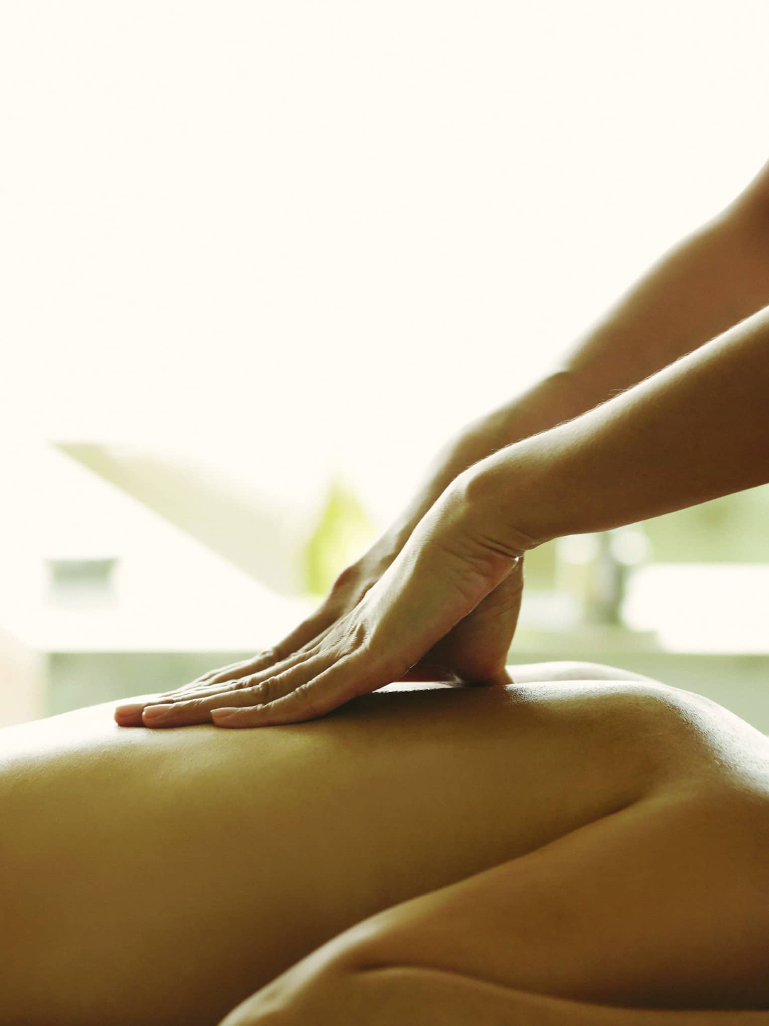 Close-up of a person receiving a relaxing back massage in a spa setting.