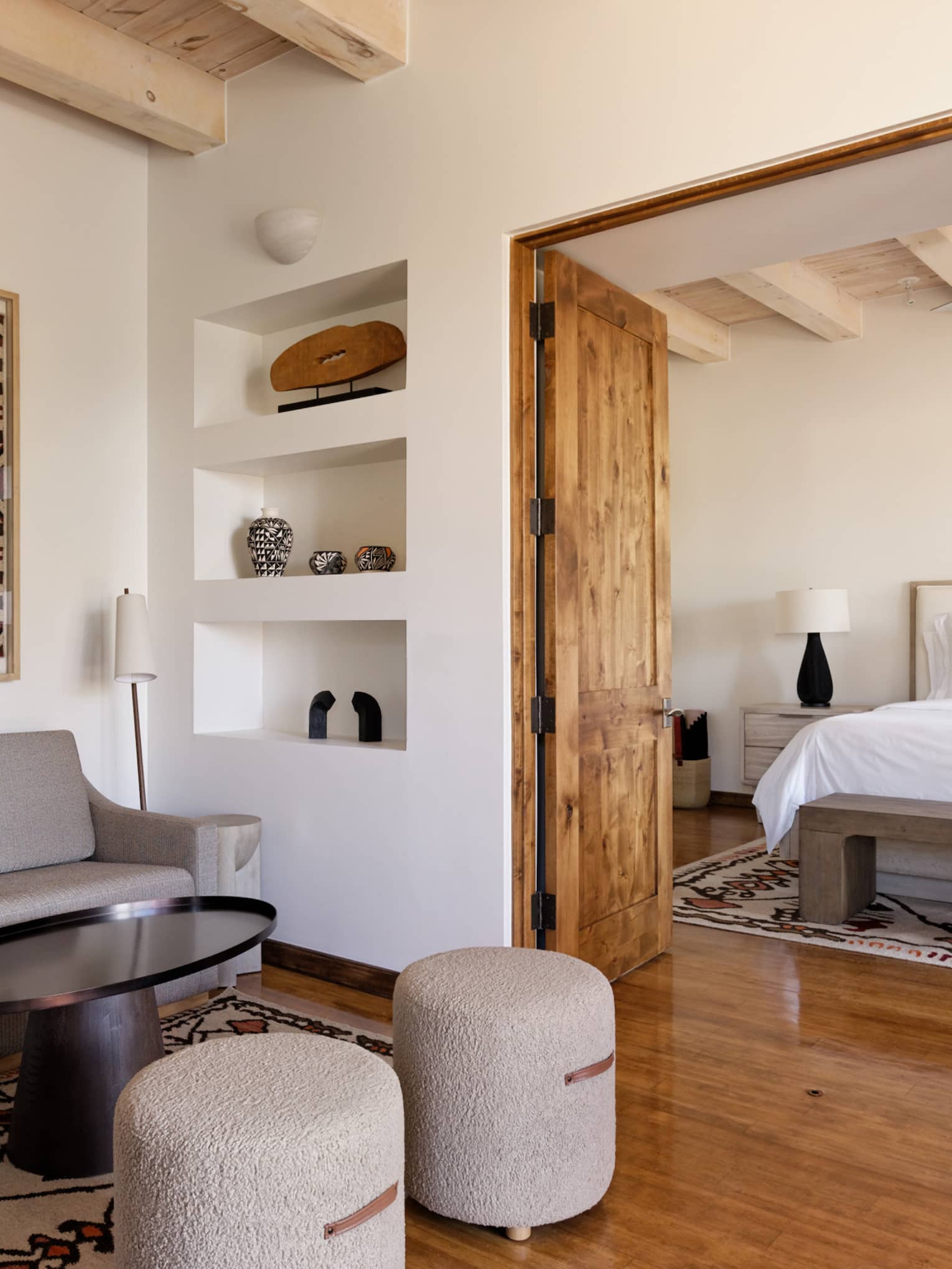 Hotel suite with bedroom and separate sitting area at Four Seasons Resort Santa Fe