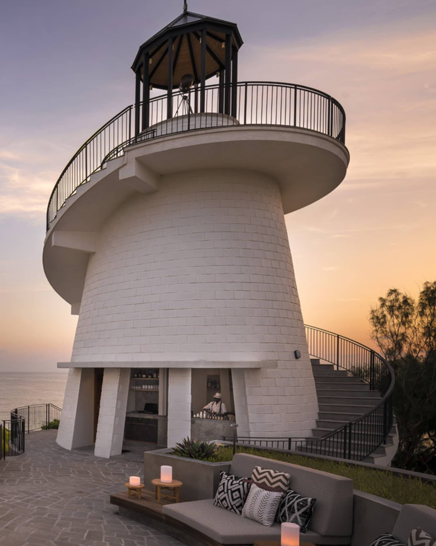 Lighthouse Restaurant illuminated at sunset with fire pit and luminaries