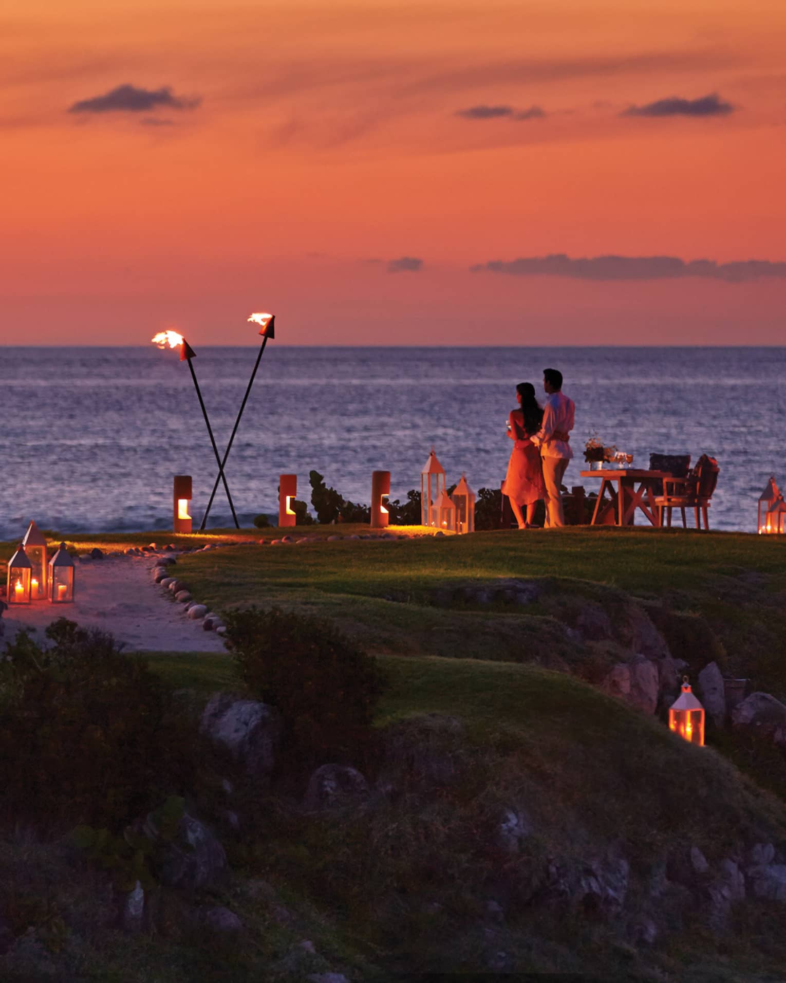 ,A group gathered for dinner outside during sunet.