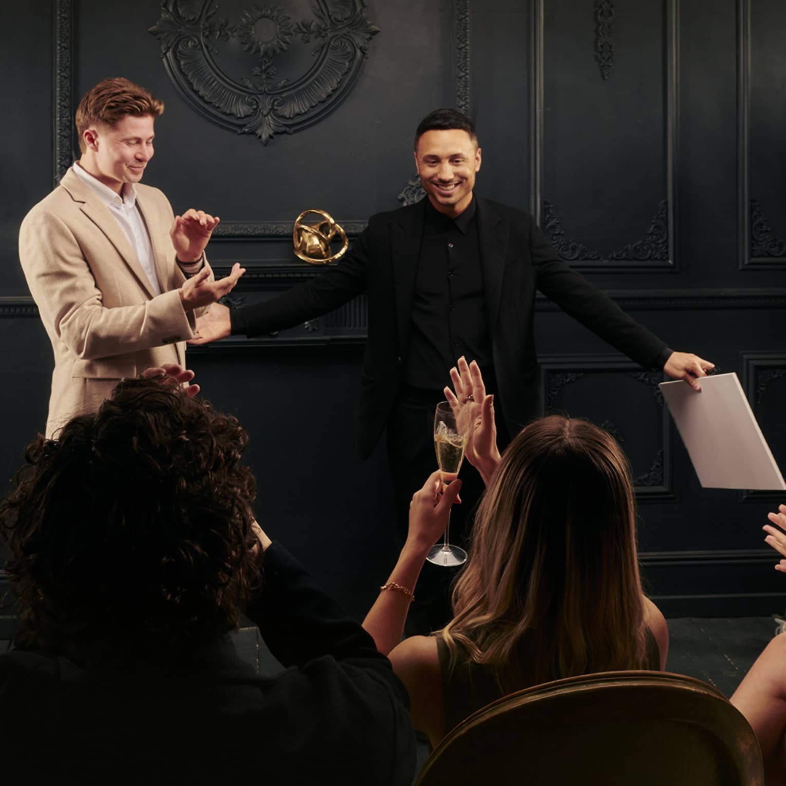 Live magic show on stage with audience clapping