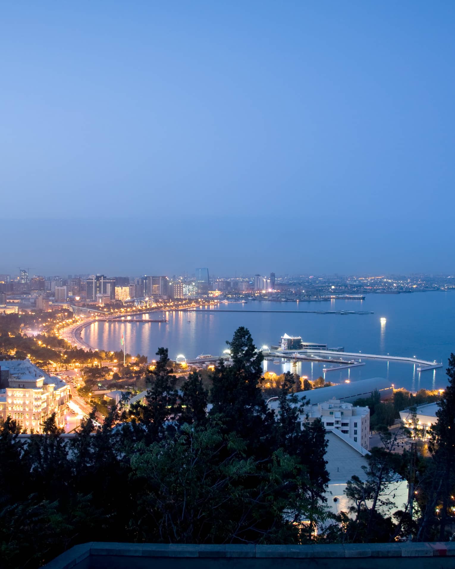 Aerial view of lights of Baku The Old City at night around Caspian Sea coastline