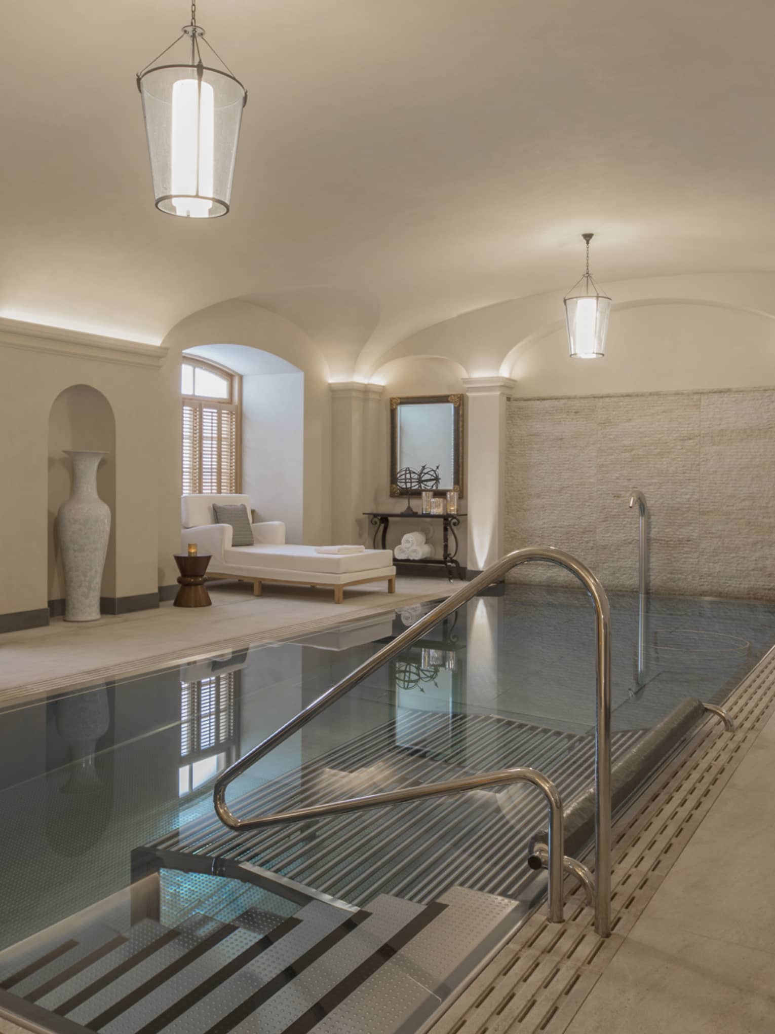 AVA Spa vitality pool  flanked by white lounge chairs under domed ceiling