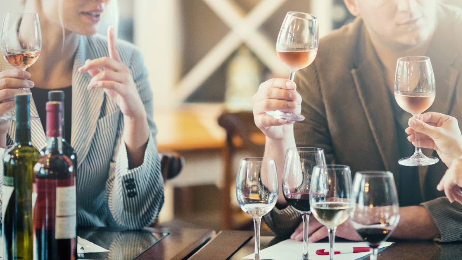 Close-up of couple with wine glasses during wine tasting