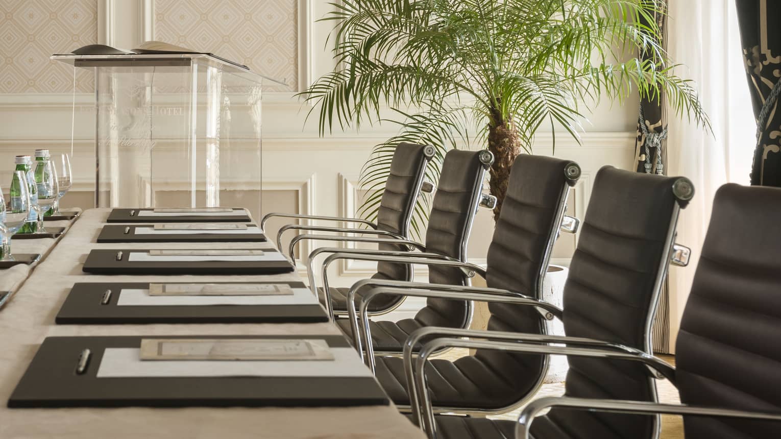 Phipps Room elegant boardroom meeting table lined with black executive chairs