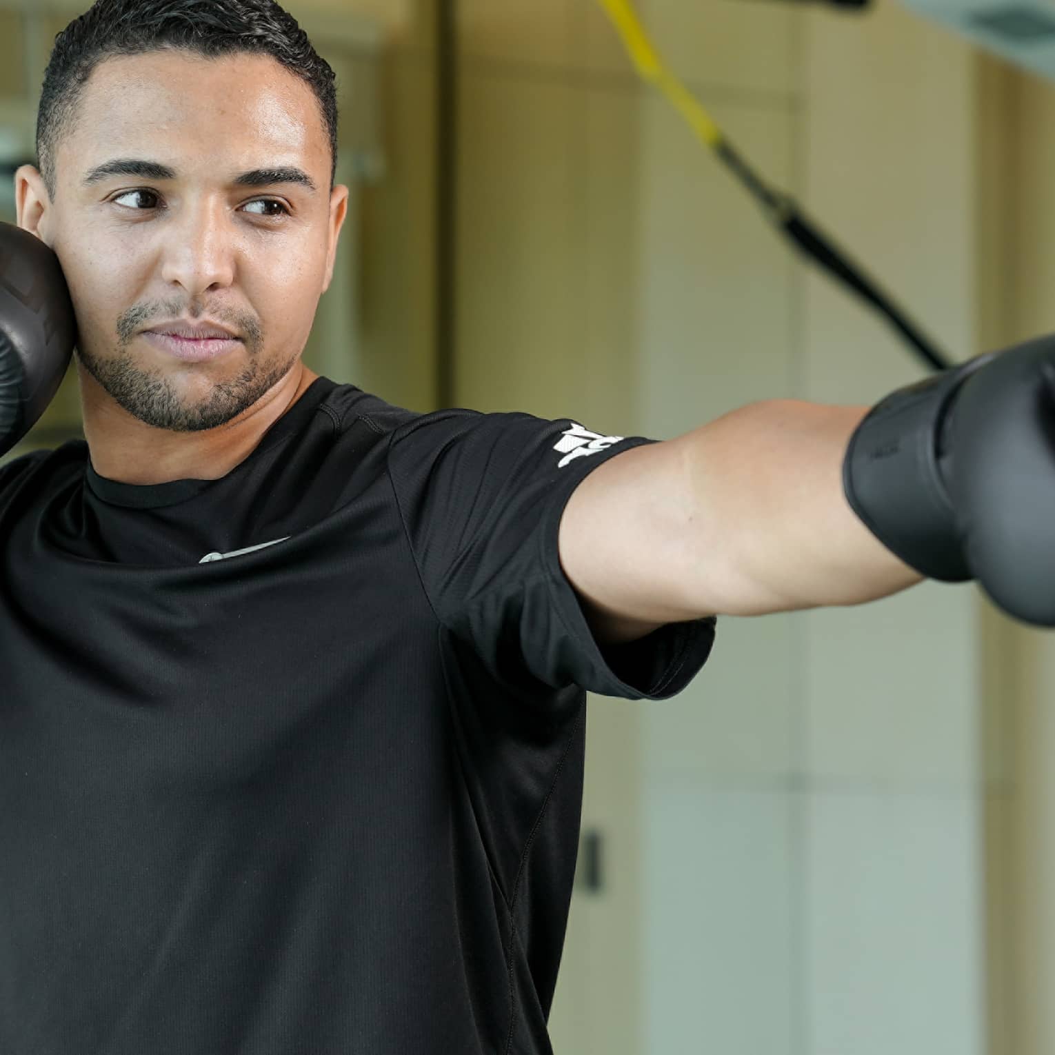 A man in boxing gloves practicing his form.