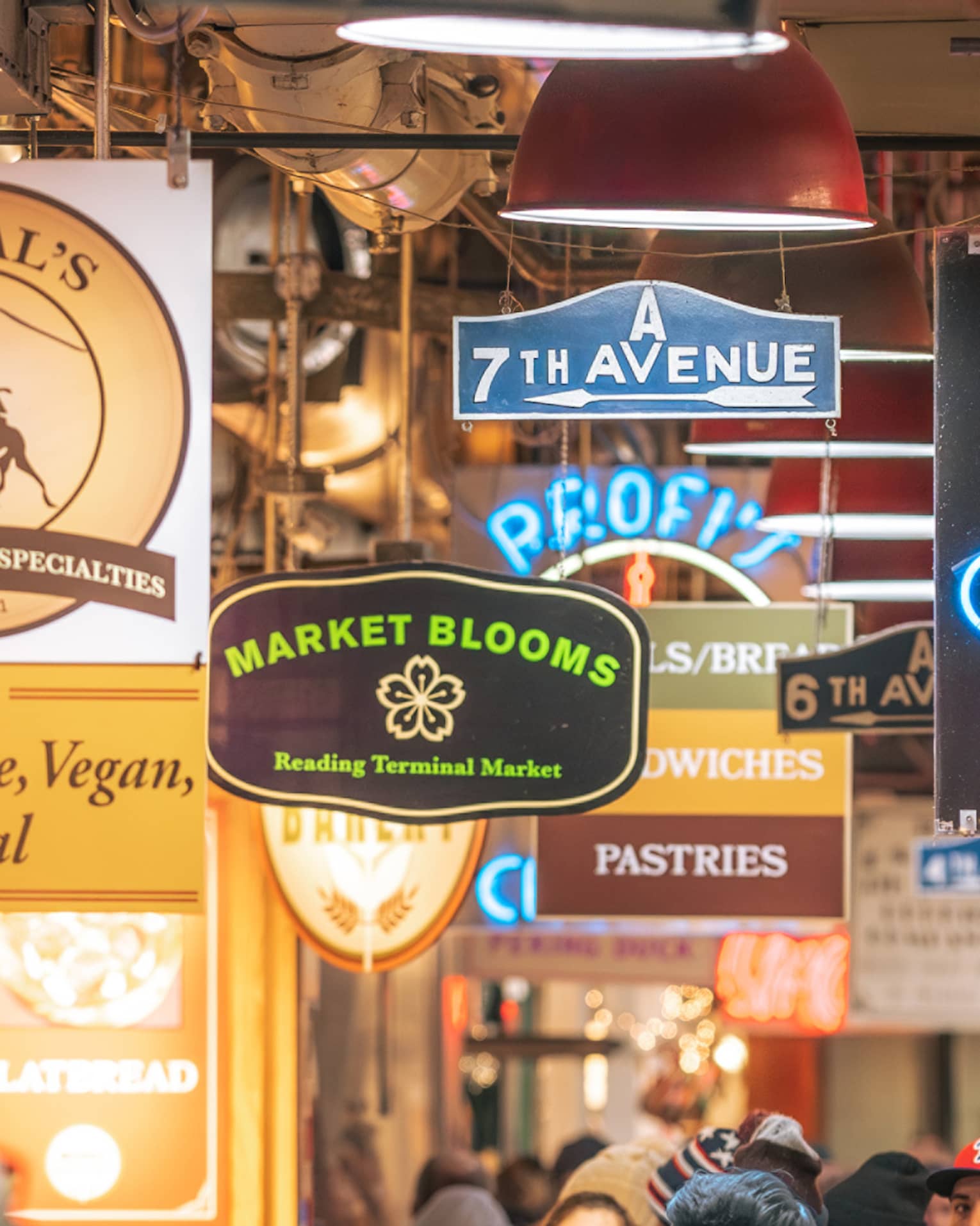 A busy street or alley with signs for food.
