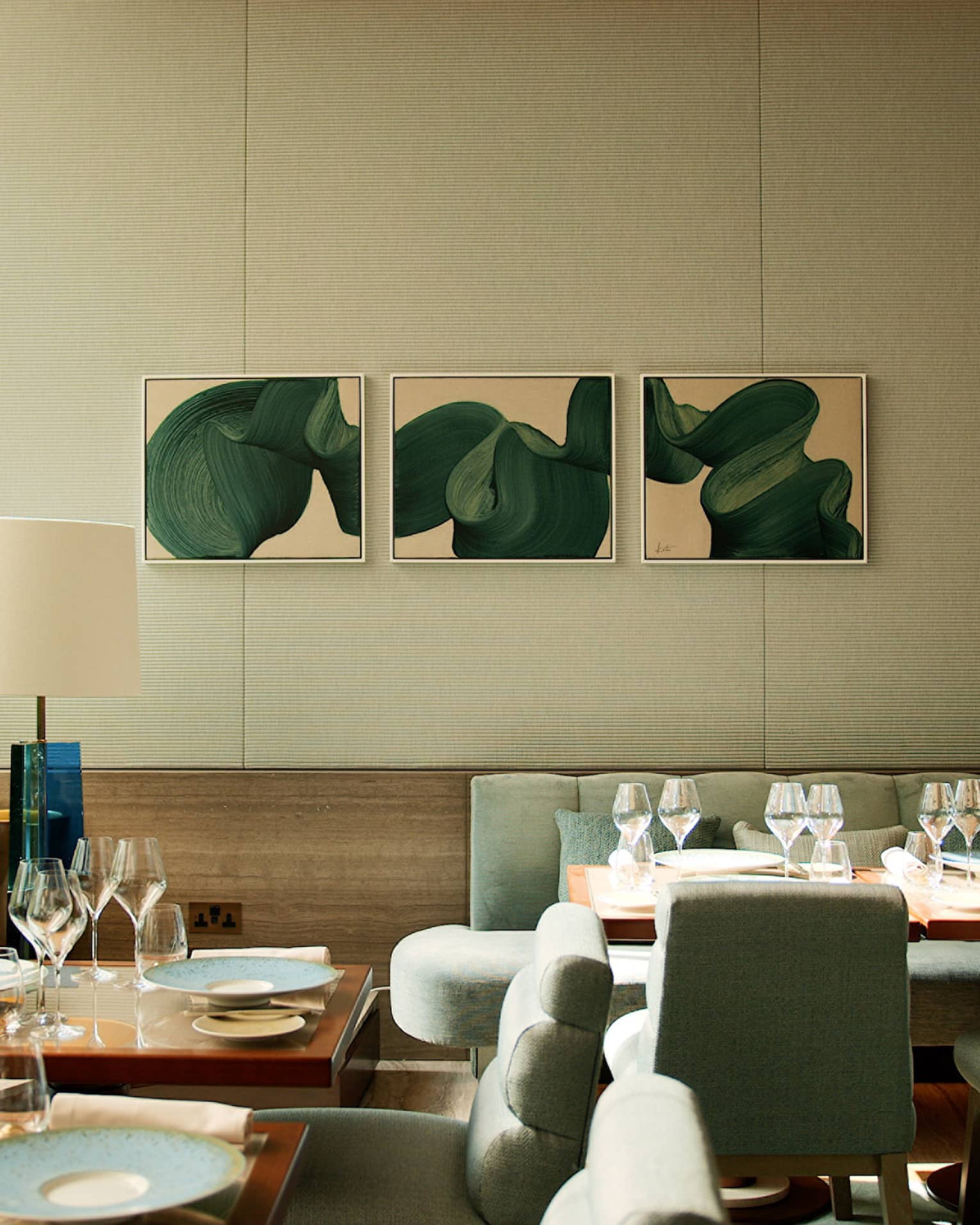 Pavyllon's elegant, modern dining room with banquette seating, muted colours and contemporary art on wall