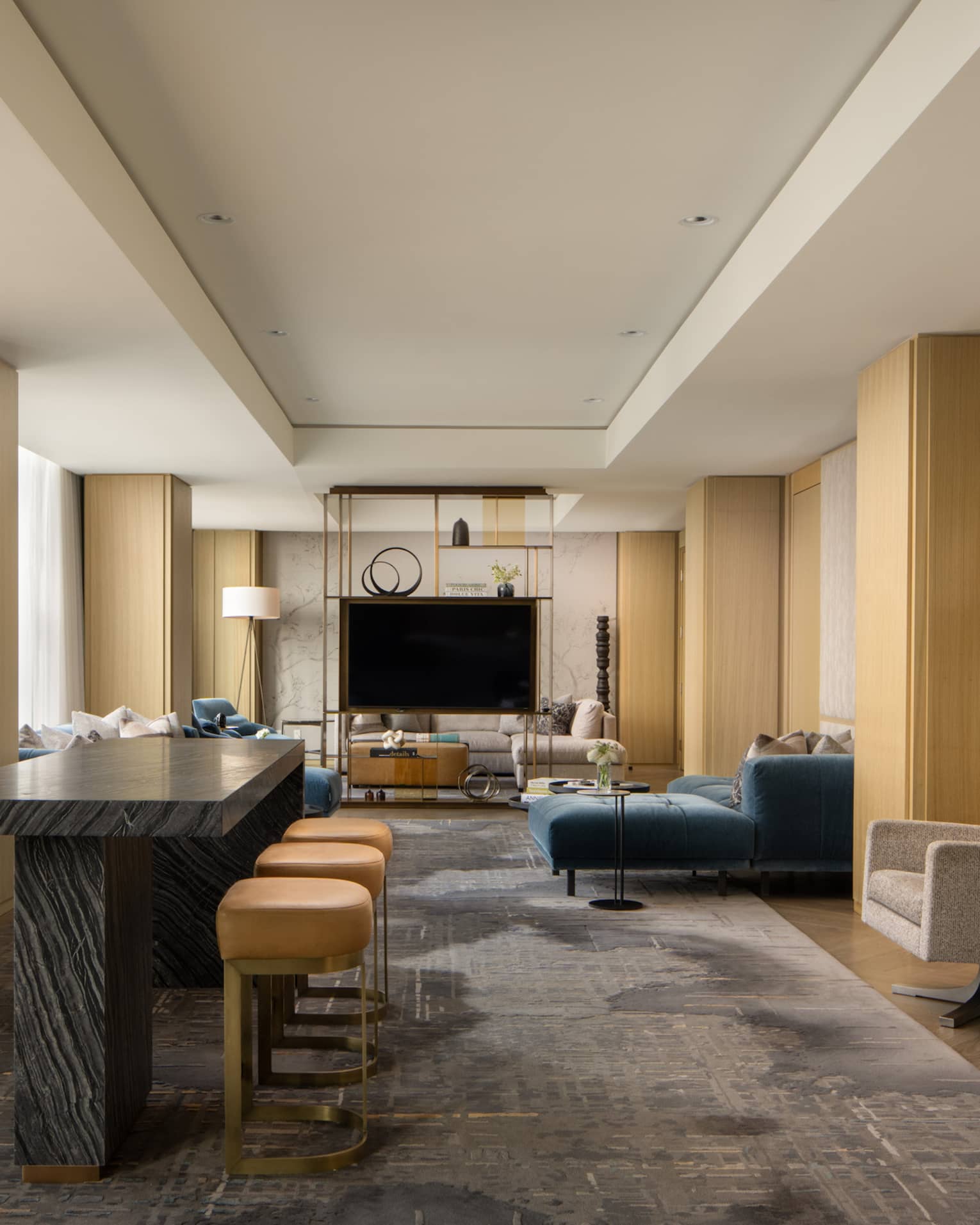 Luxury suite with a black table with stools, stylish display shelf, TV, armchairs and blue sofa