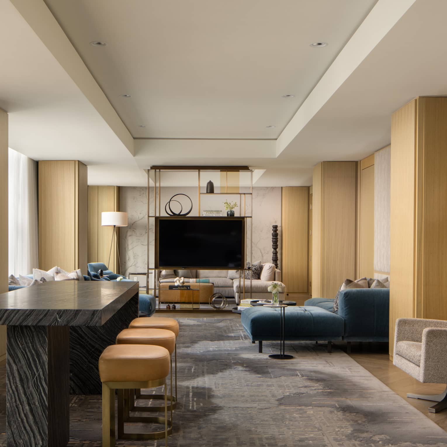 Luxury suite with a black table with stools, stylish display shelf, TV, armchairs and blue sofa